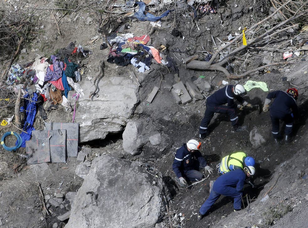 Searchers work to collect debris and find the second black box at the crash site of the Germanwings Airbus A320 in the French Alps, 29 March 2015