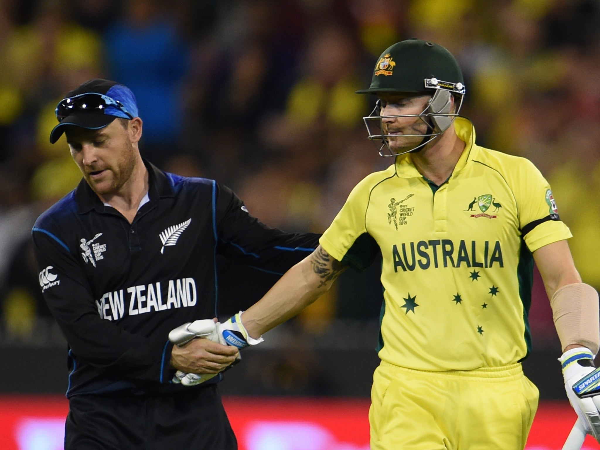 Australia's batsman Michael Clarke (R) shakes hands with New Zealand's captain Brendon McCullum in his last cricket one-day international as Australia close in on a World Cup final victory