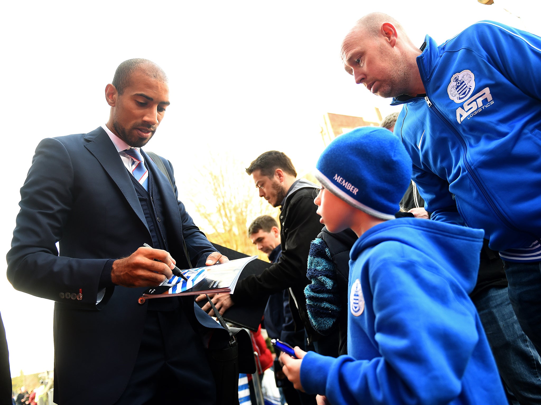 Karl Henry of QPR signs autographs for fans