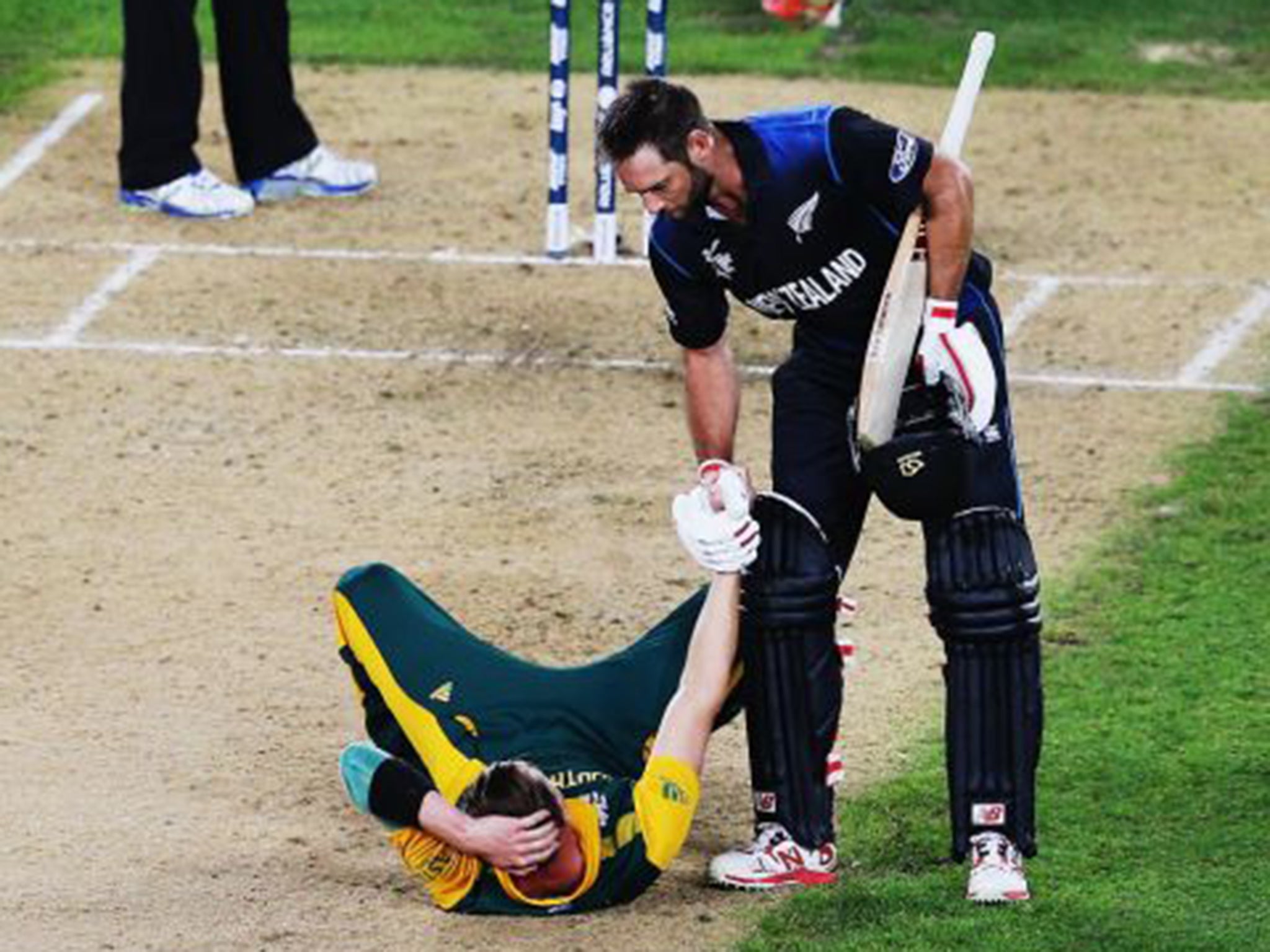 New Zealand’s Grant Elliott helps South Africa’s Dale Steyn up after their semi-final