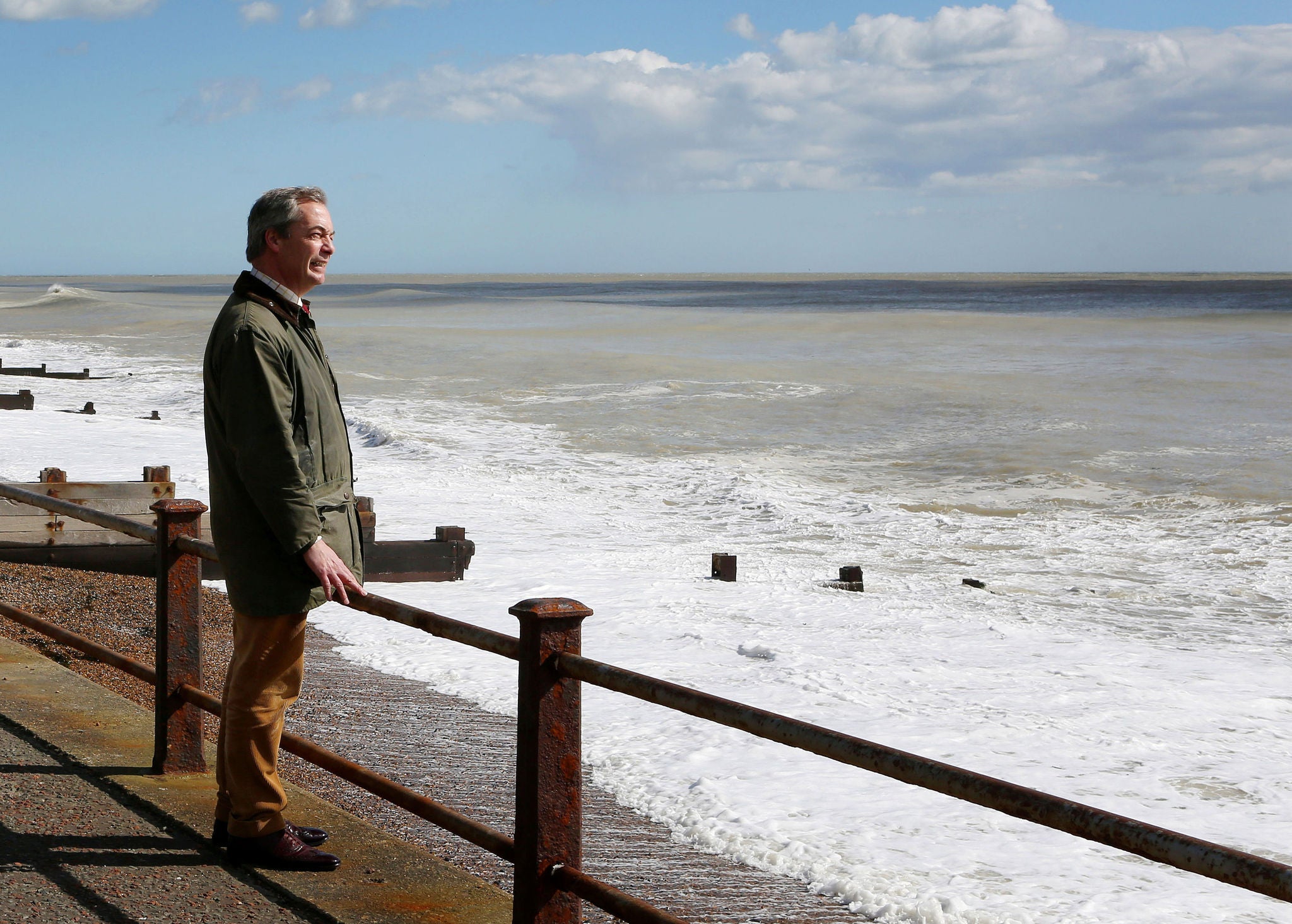 Nigel Farage has a look out to sea during his immigration policy launch in Dover (PA)