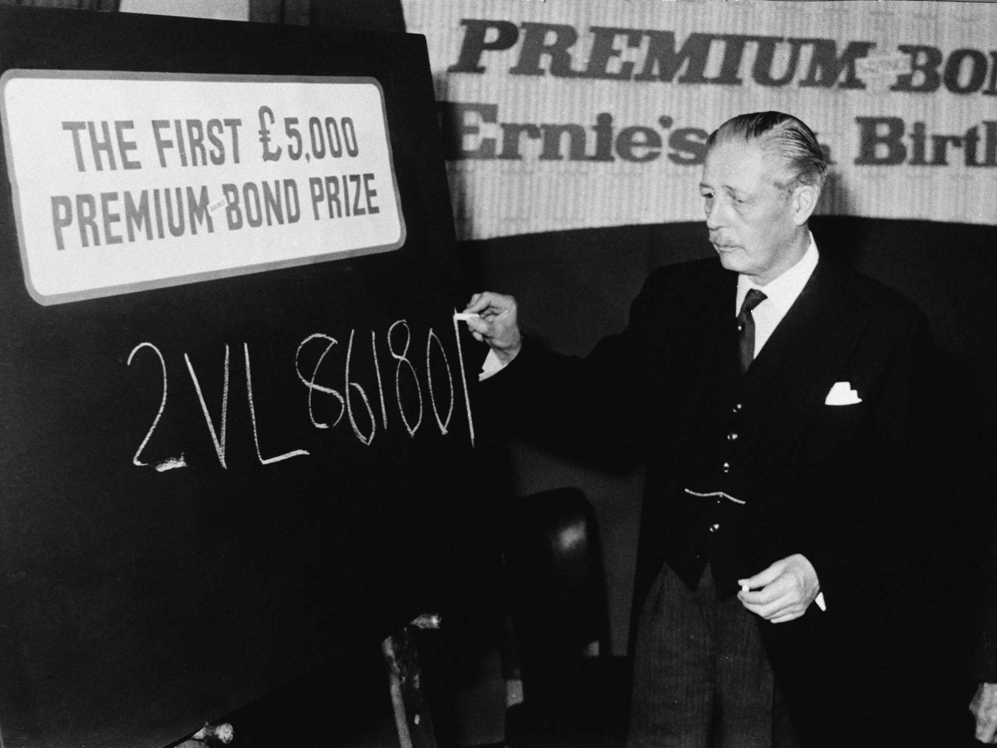 Harold Macmillan writes the number of the first winner of the Premium Bond prize draw.