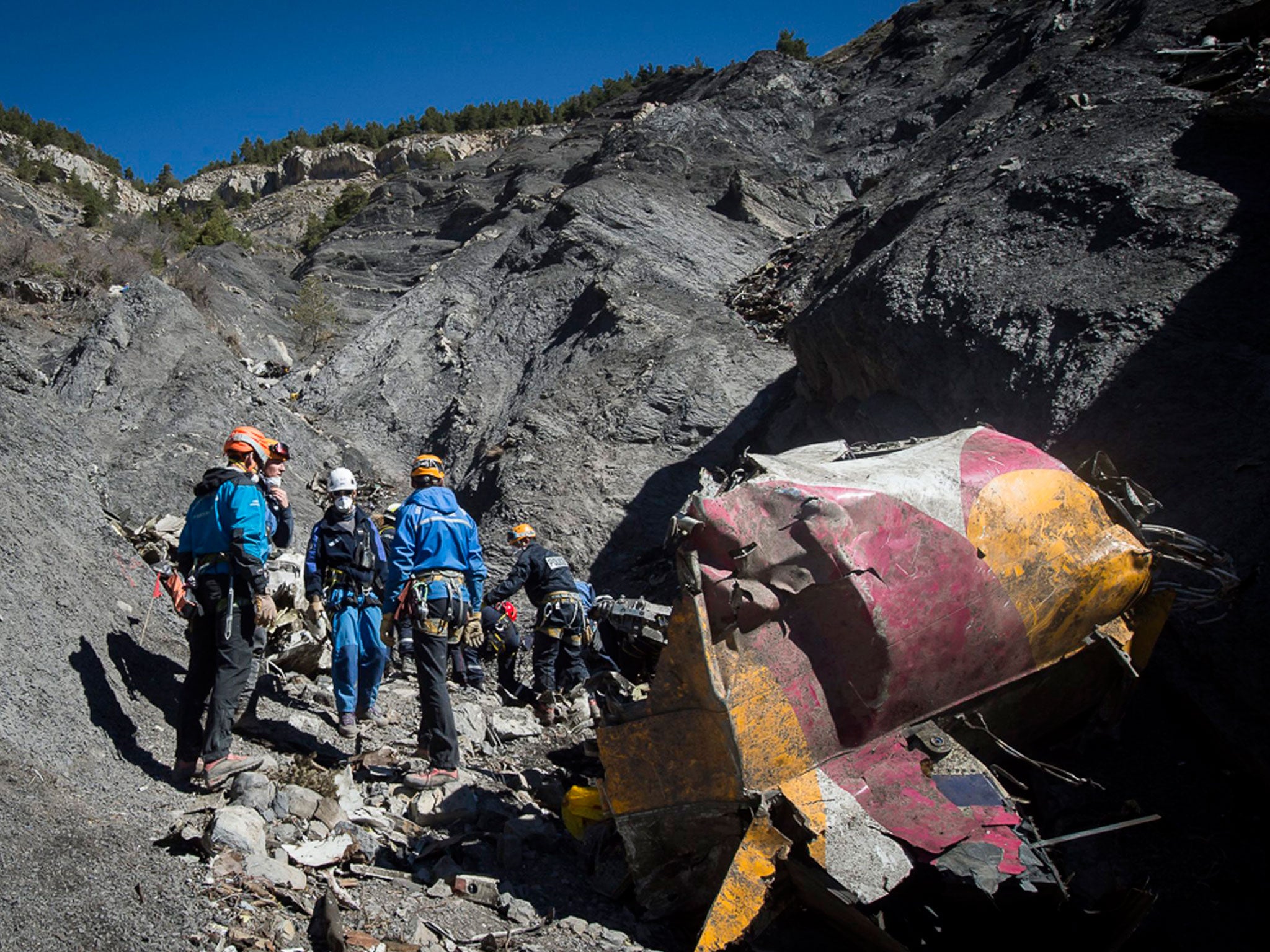Rescue workers and investigators collect debris at the crash site of the Germanwings Airbus A320, near Seyne-les-Alpes