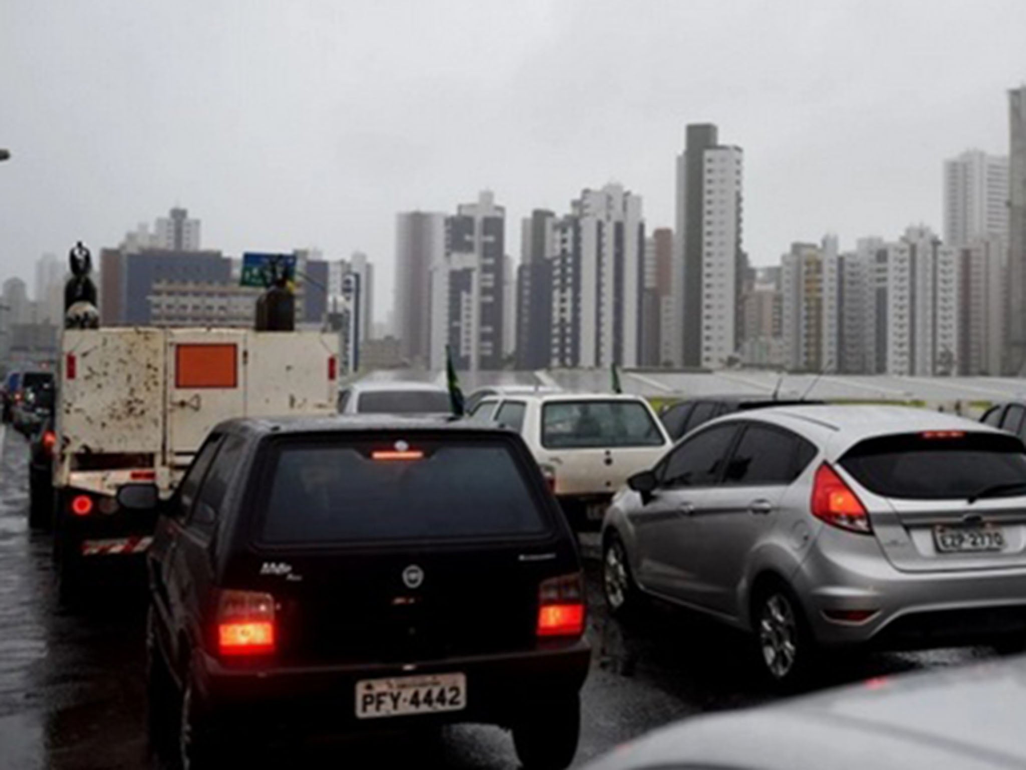 Cars queue in traffic under the rain in Recife ahead of a World Cup soccer match in June 2014.