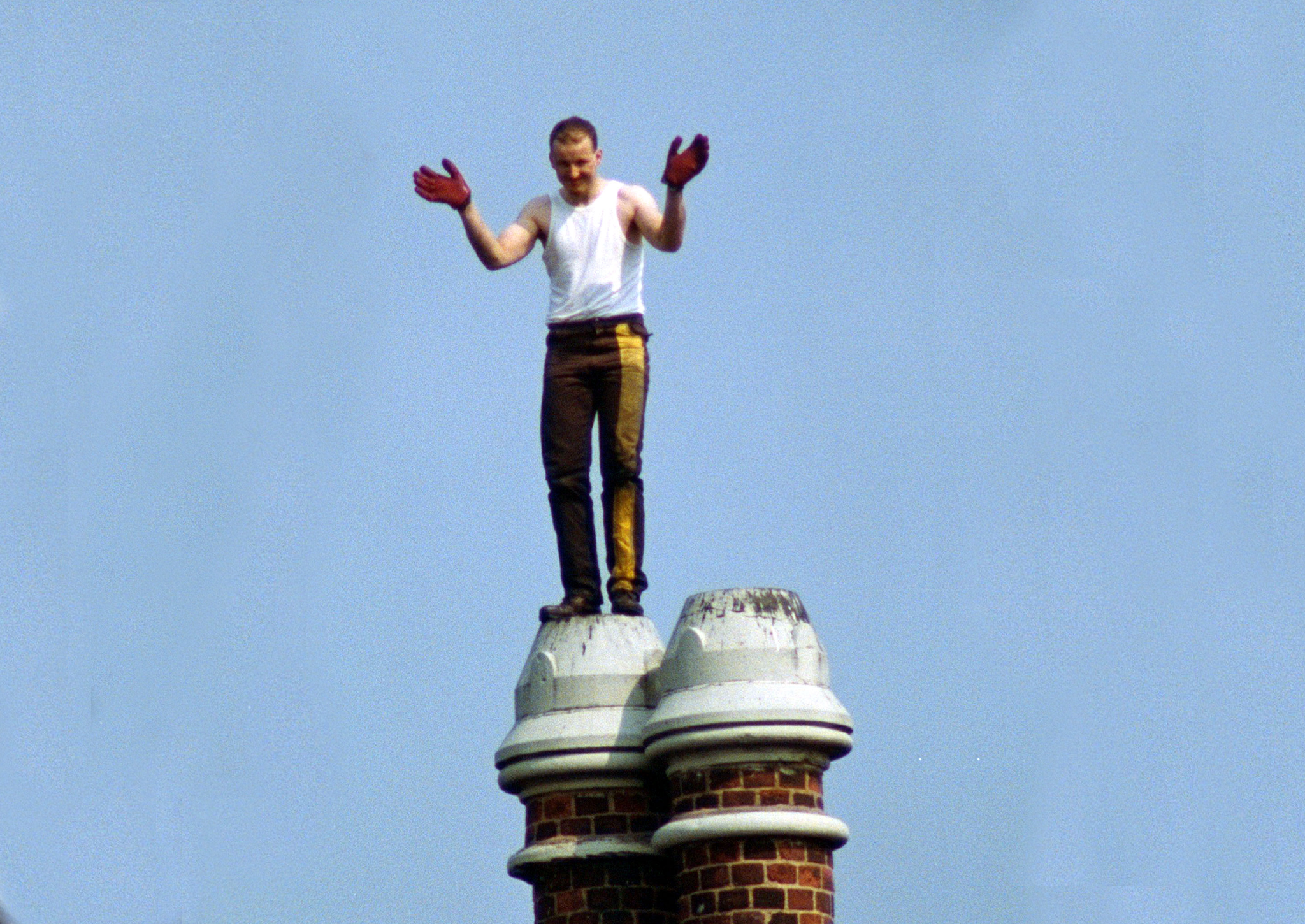 A prisoner stands atop a chimney during the Strangeways Prison riot in 1990