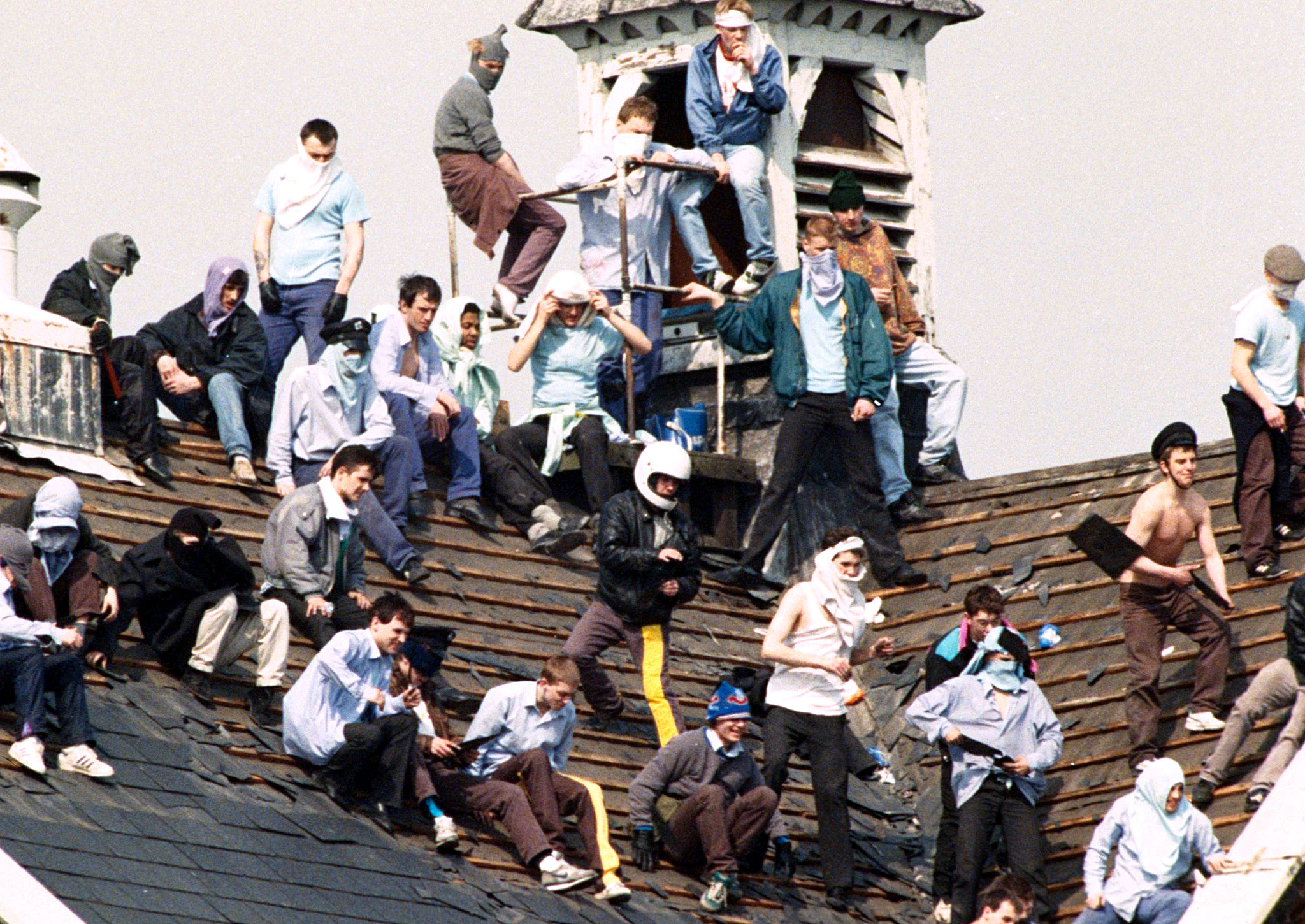 Rioting prisoners congregate on the roof of Manchester's Strangeways prison in 1990