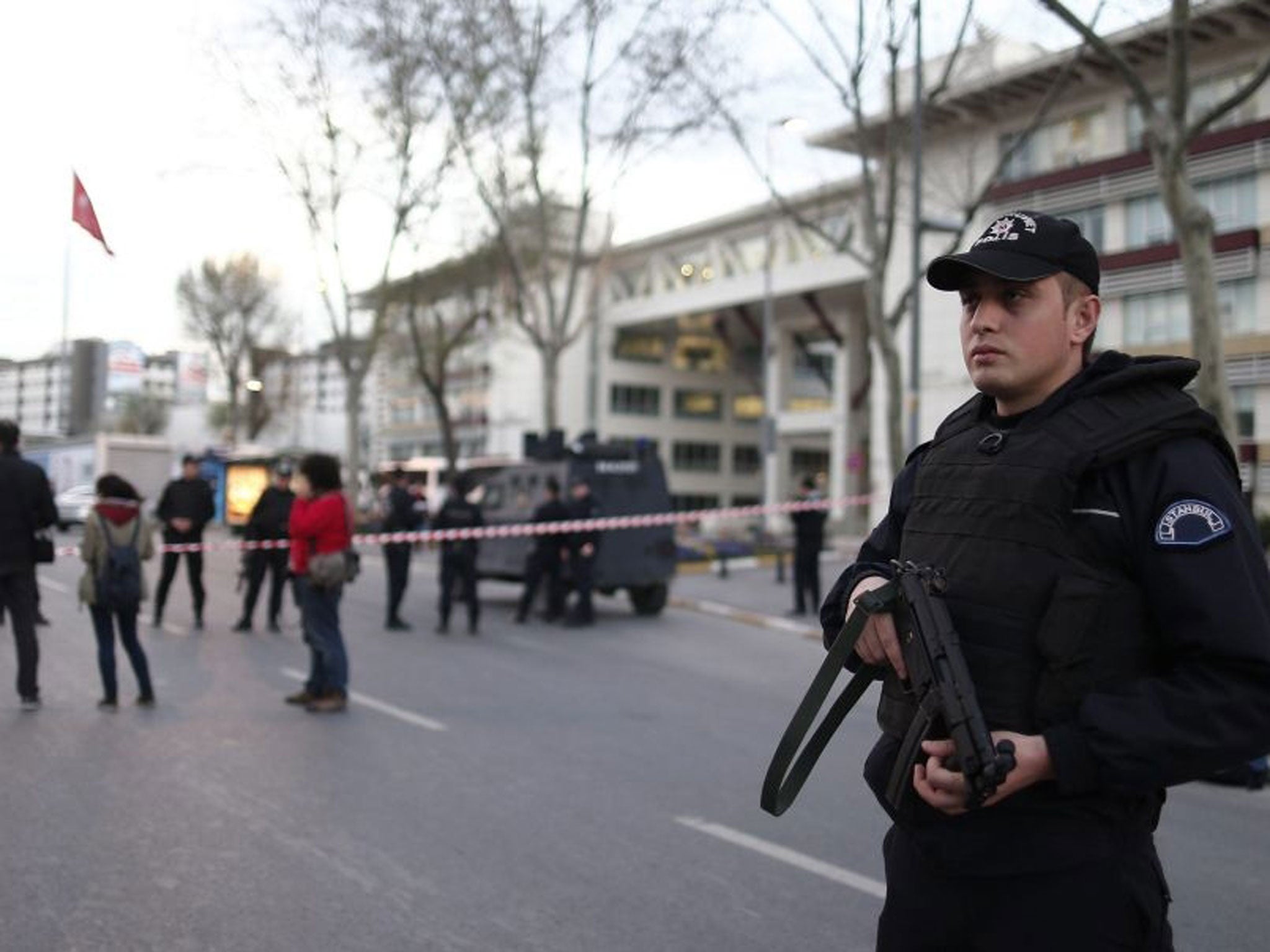 Turkish policemen secure the area in front of the Istanbul Police Headquarter after an attack by an armed woman and man, in Istanbul.