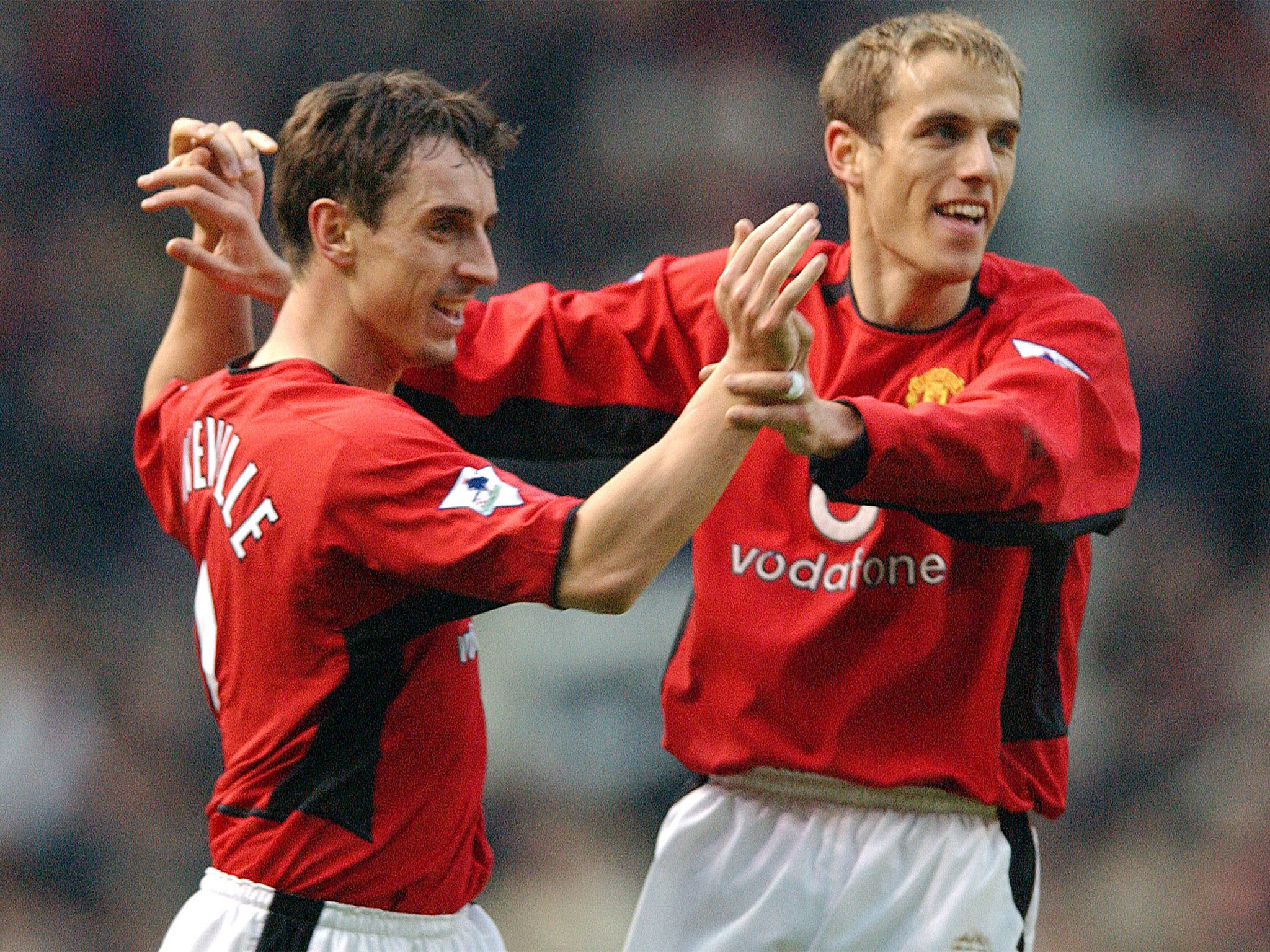 Brothers Gary and Phil celebrate a Manchester United goal in 2002 (Getty)