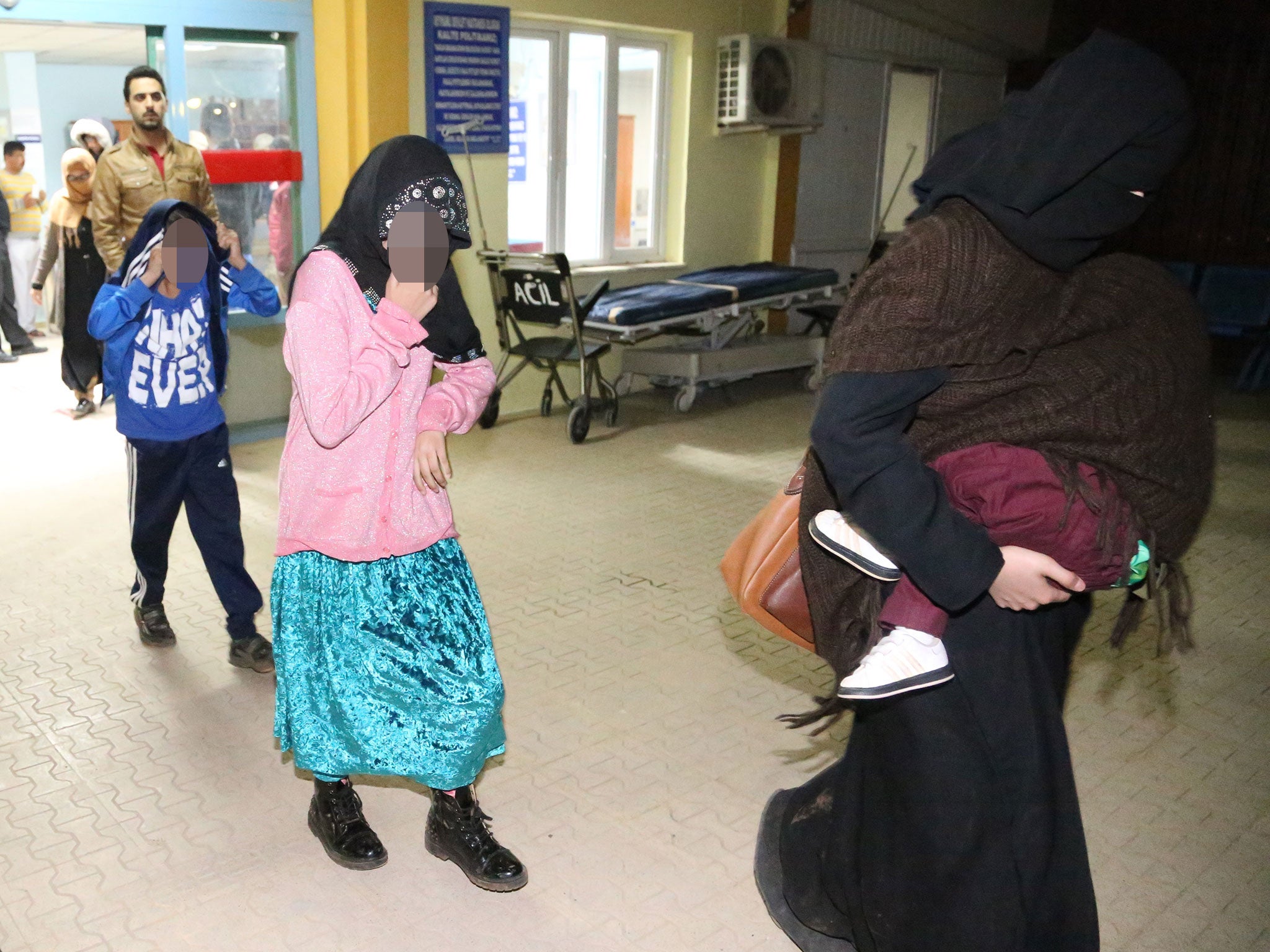 Detained British people leave an hospital after they undergo medical check up and fingerprinting in Hatay southern of Turkey