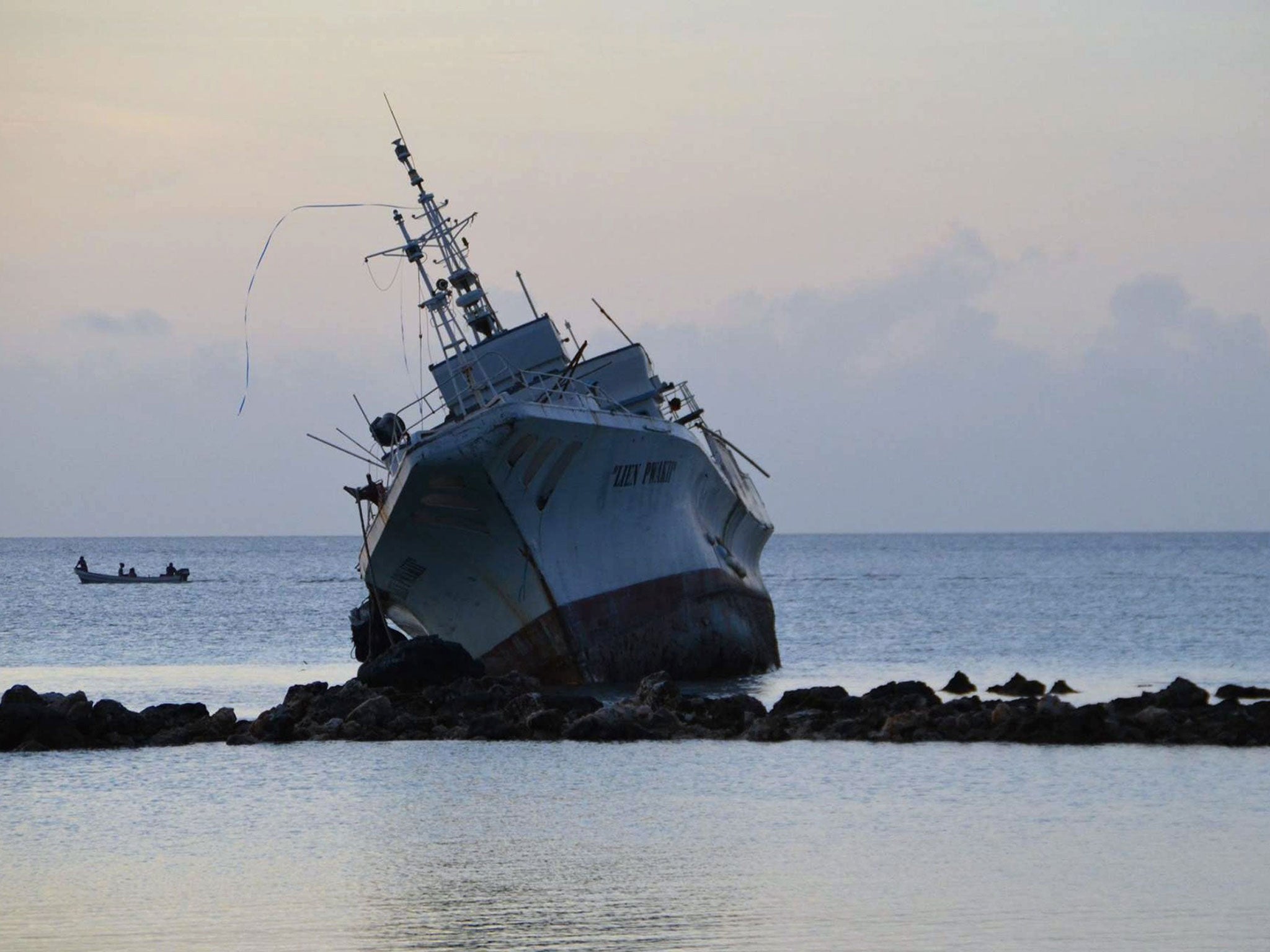 A ship rests on rocks on 29 March, 2015 after it ran aground during storms brought on by Super Typhoon Maysak