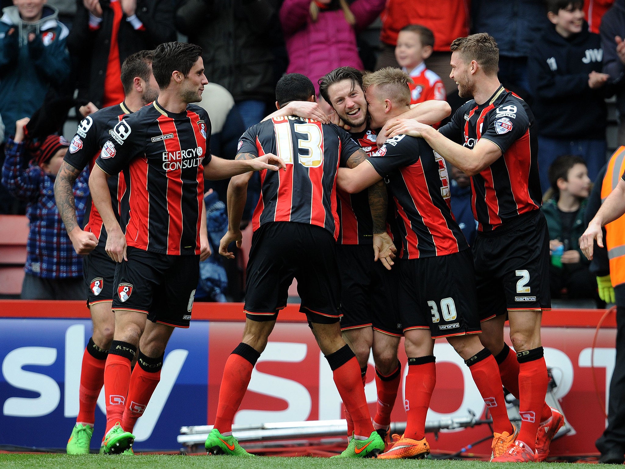 Harry Arter (centre) celebrates with his Bournemouth team-mates during their win over rivals
Middlesbrough at Dean Court