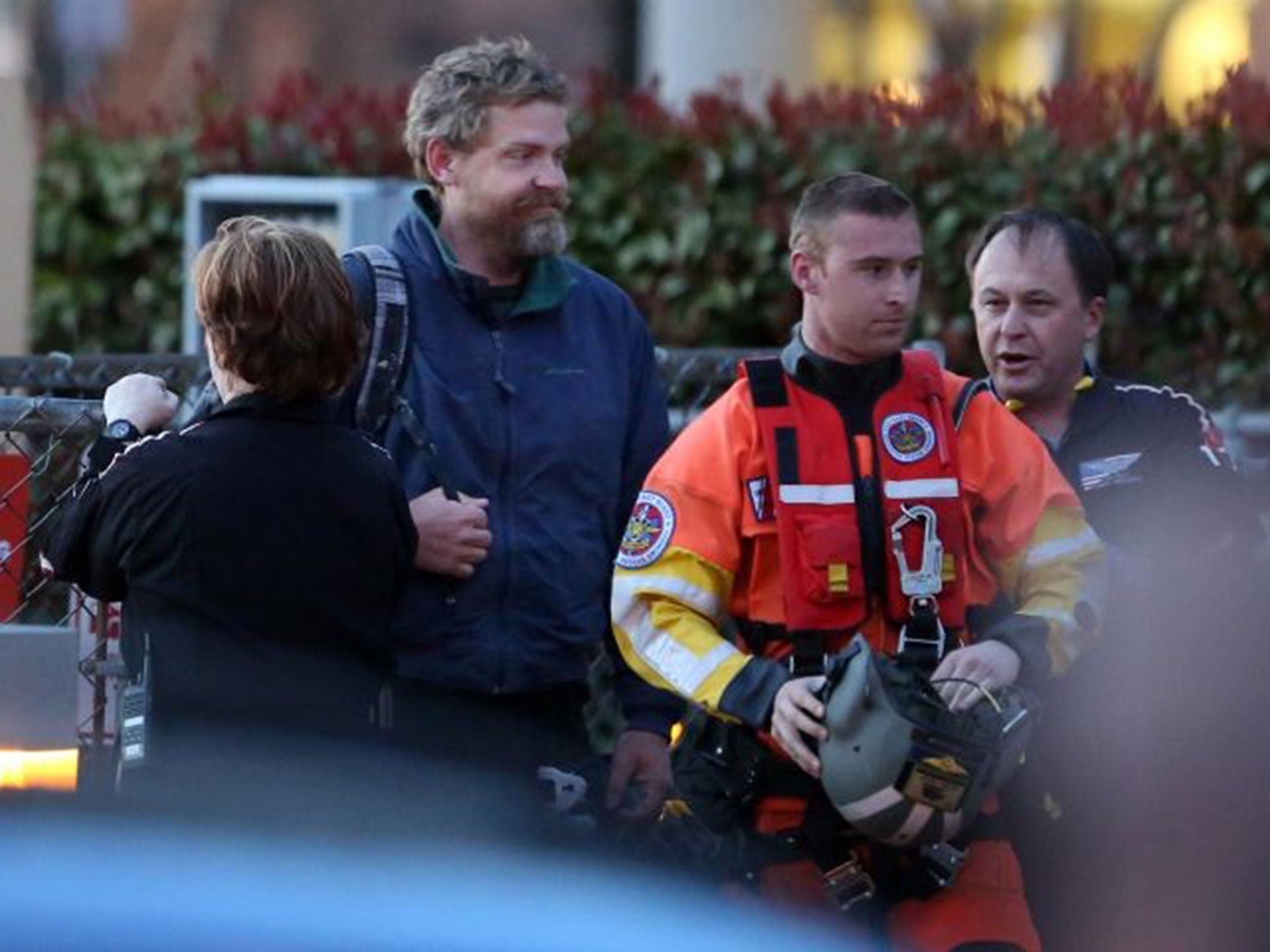 Louis Jordan, second from left, walks from the Coast Guard helicopter to the Sentara Norfolk General Hospital in Norfolk, after being rescued on 2 April