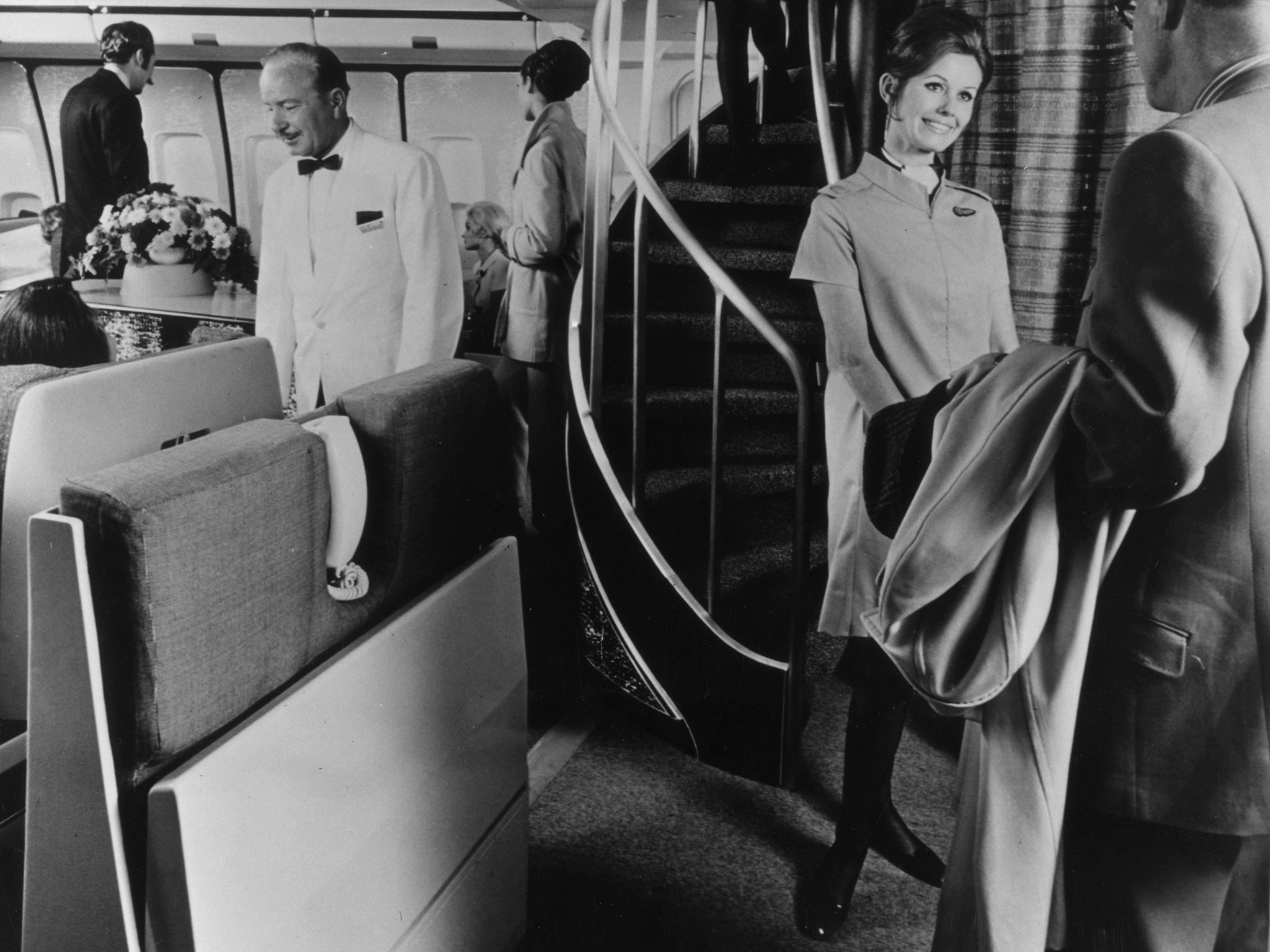 Smartly dressed passengers are welcomed aboard a BOAC flight in 1970