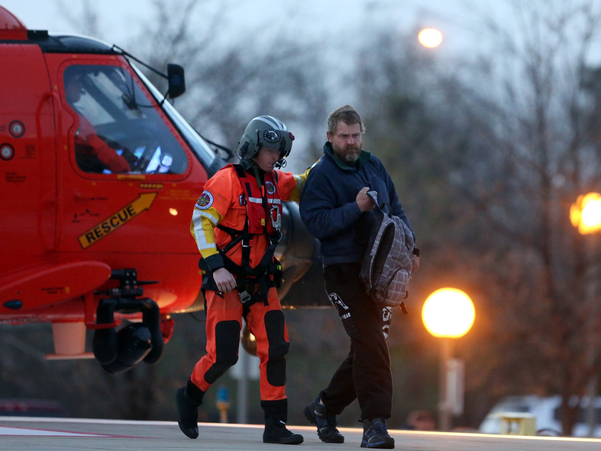 Louis Jordan walks from the Coast Guard helicopter to Sentara Norfolk hospital in Virginia