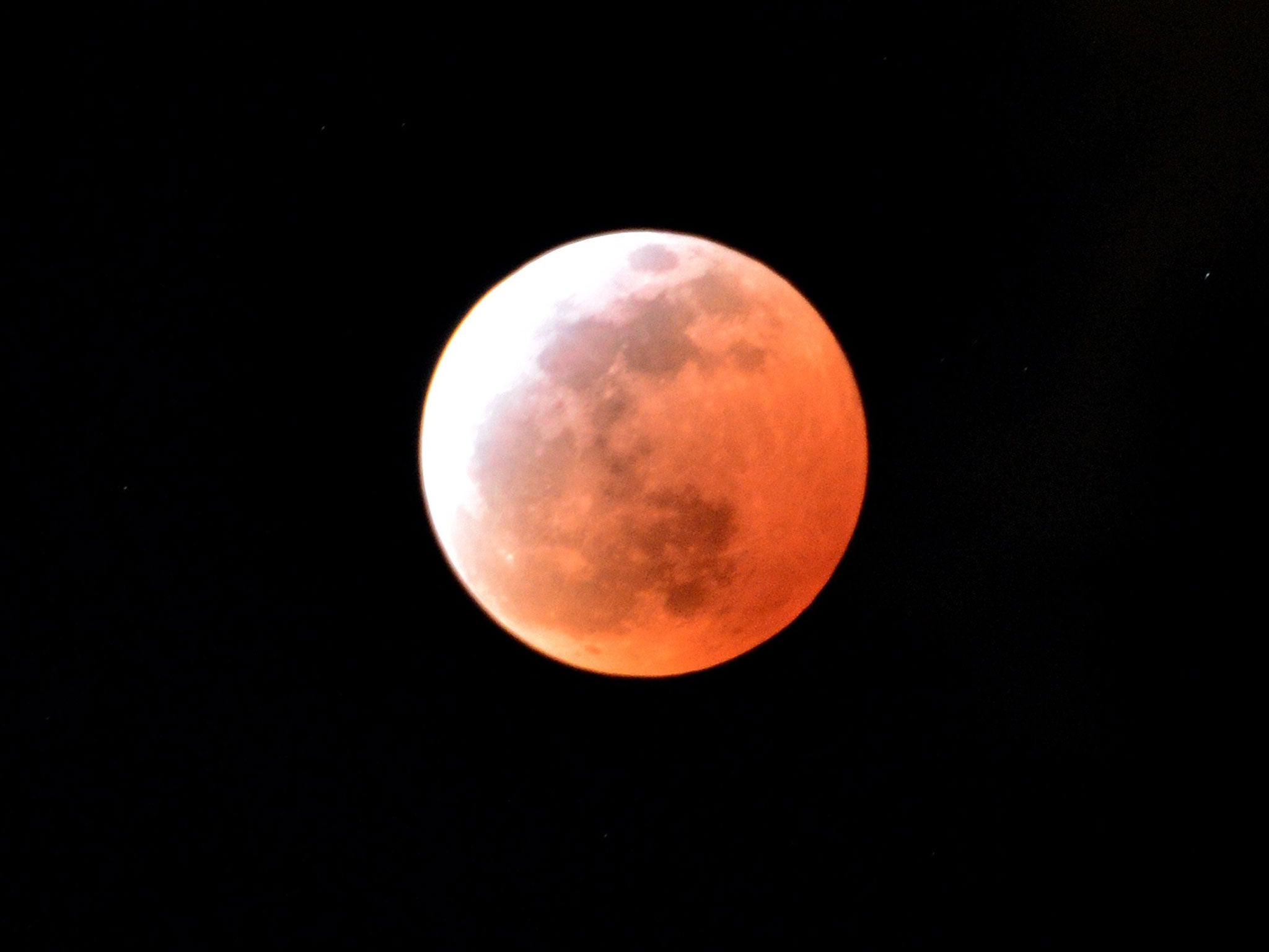A total lunar eclipse is seen in Utsunomiya in Tochigi prefecture, 100km north of Tokyo on April 4, 2015. Sky-gazers in part of the Pacific Rim enjoyed an "unusually brief" total eclipse of the Moon. Getty Images.