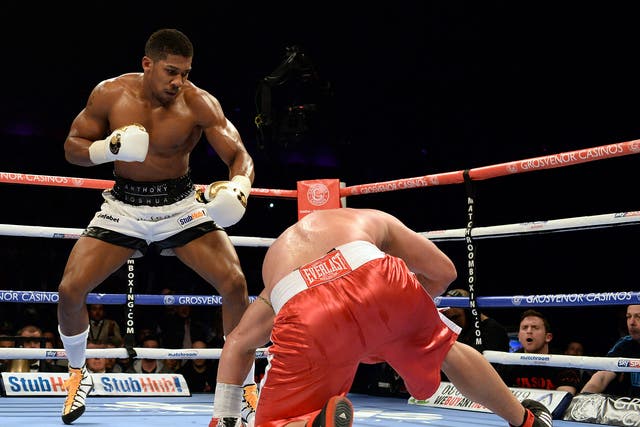 Anthony Joshua (L) in action with Jason Gavern