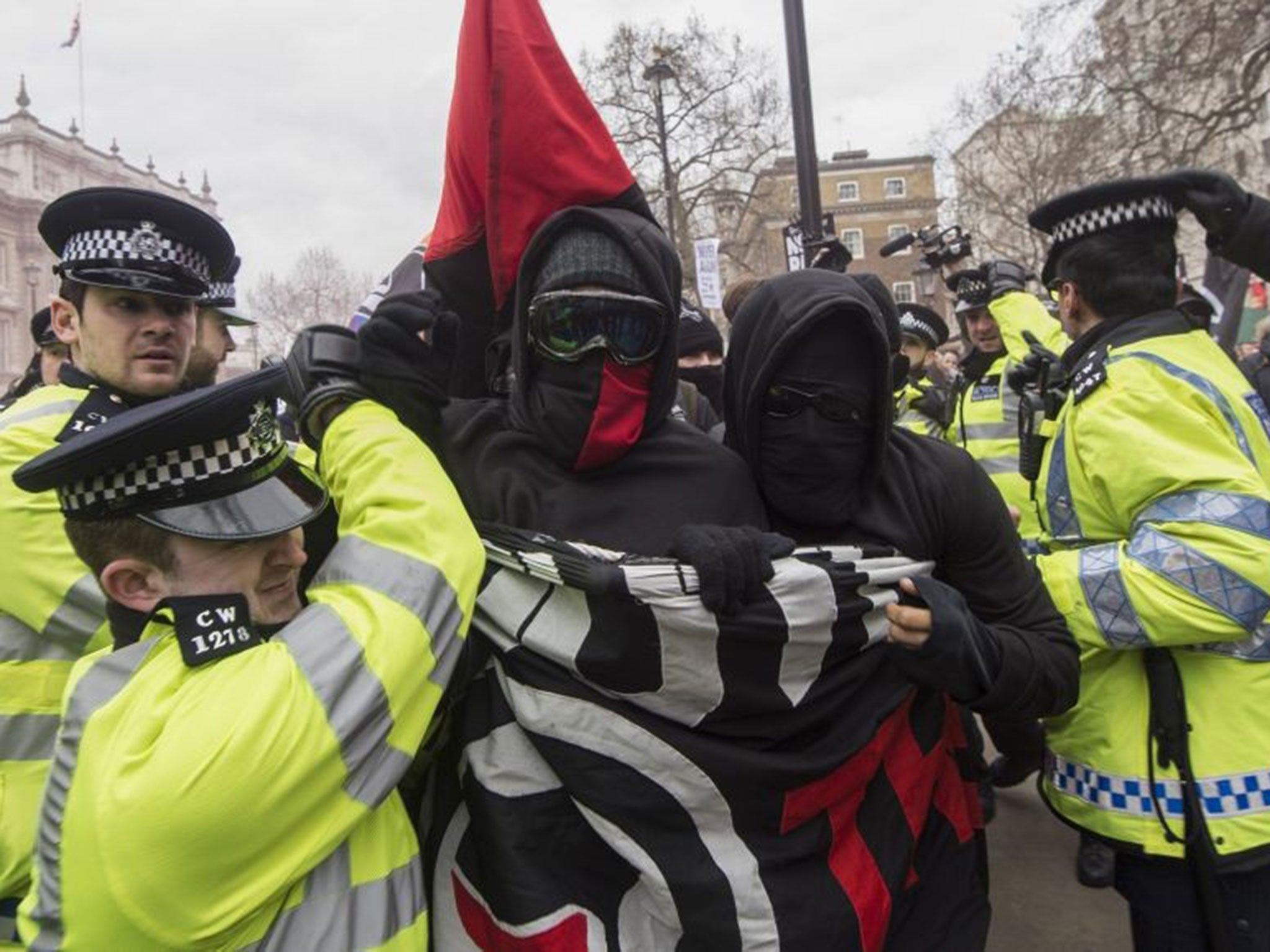 Police officers scuffle with anti-fascists on Whitehall during a rally by the British off-shoot of the Pegida movement in central London on April 4
