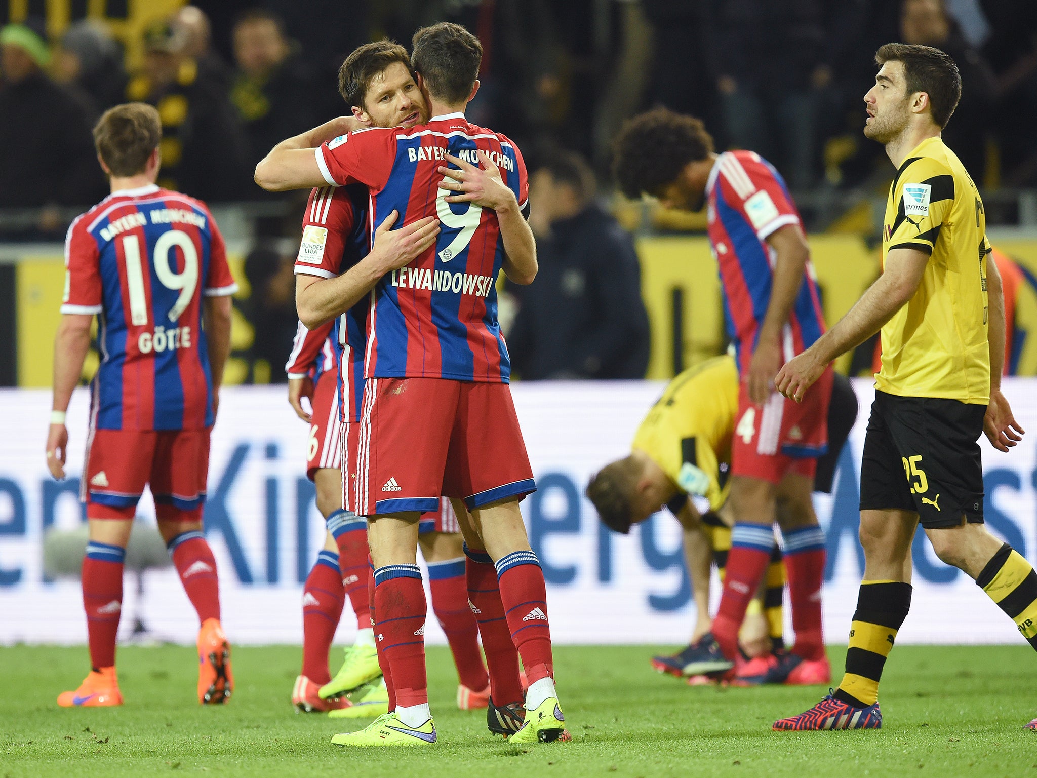 Xabi Alonso and Robert Lewandowski celebrate Bayern's victory over Borussia Dortmund