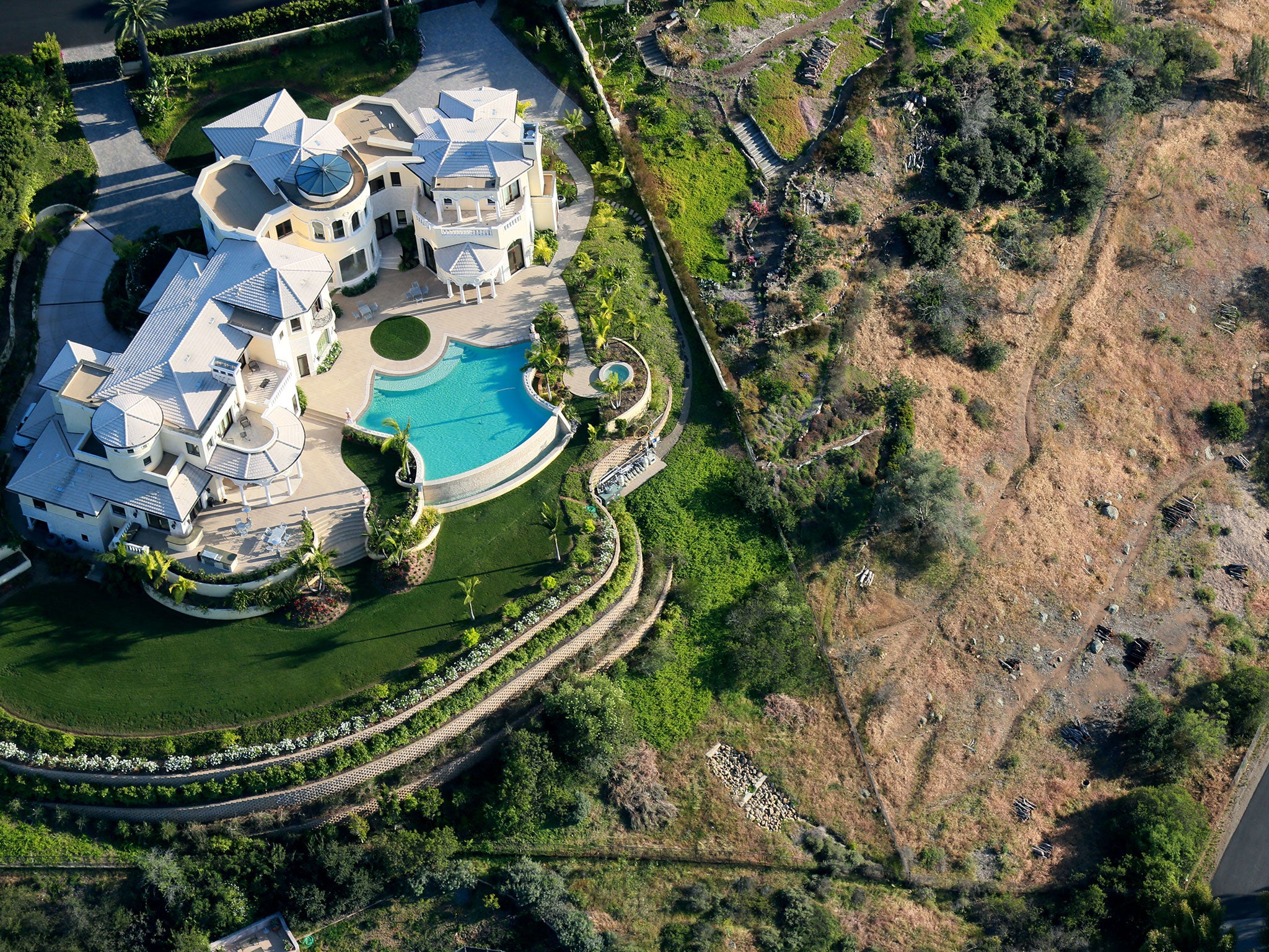 The stark contrast between watered lawns and brown hillside in San Diego