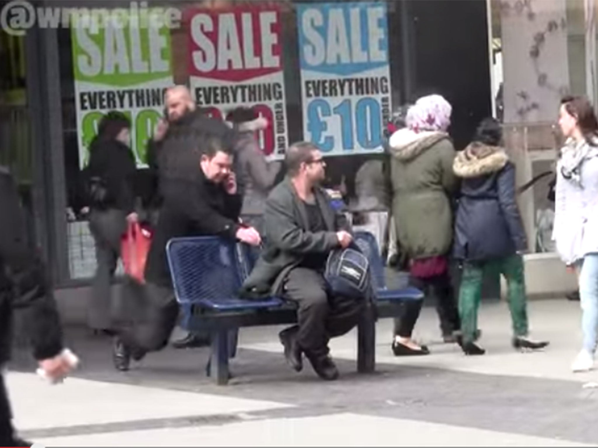 Man is pickpocketed by magicians as he sits on bench