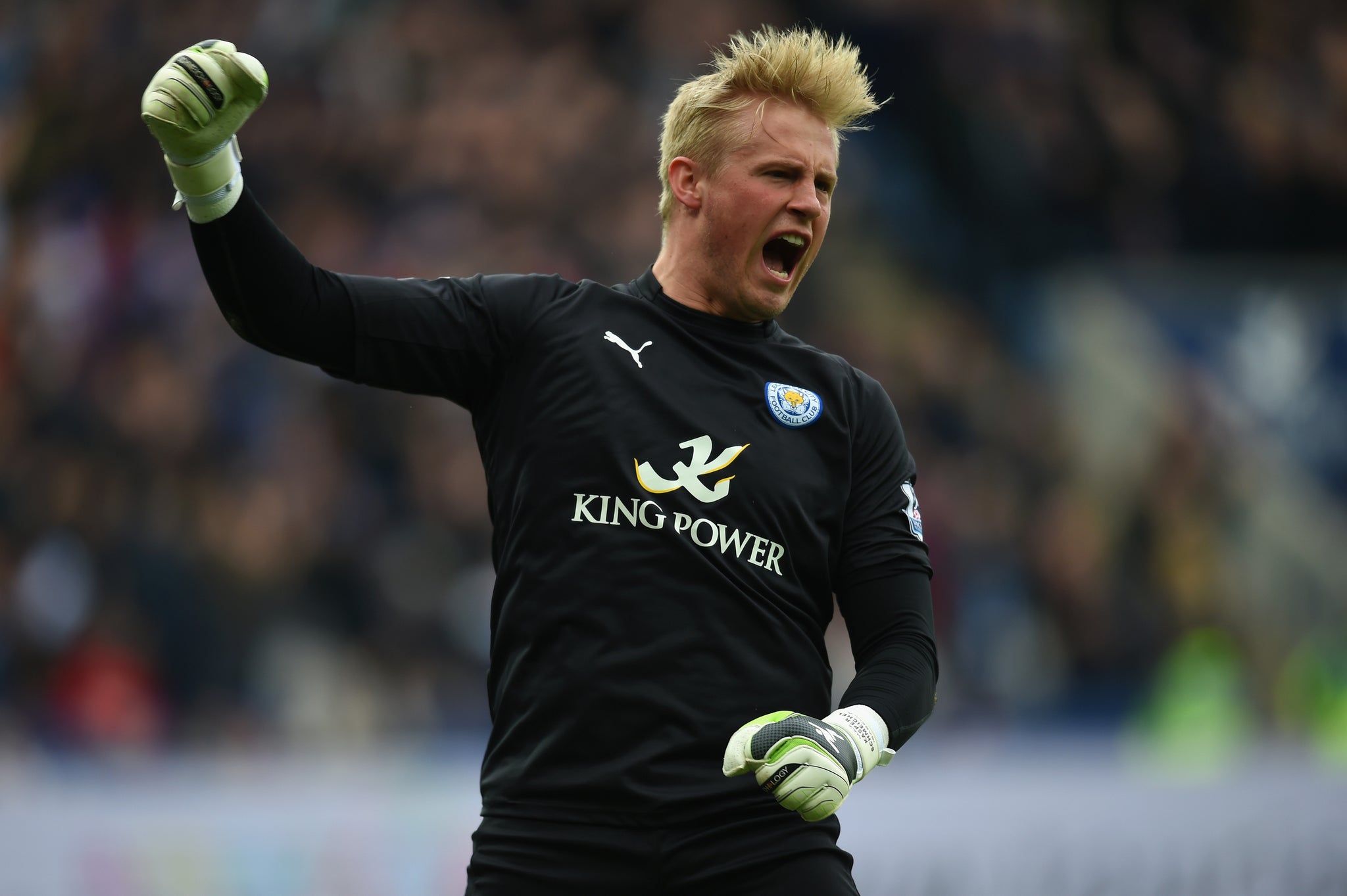 Kasper Schmeichel celebrates Esteban Cambiasso's opener