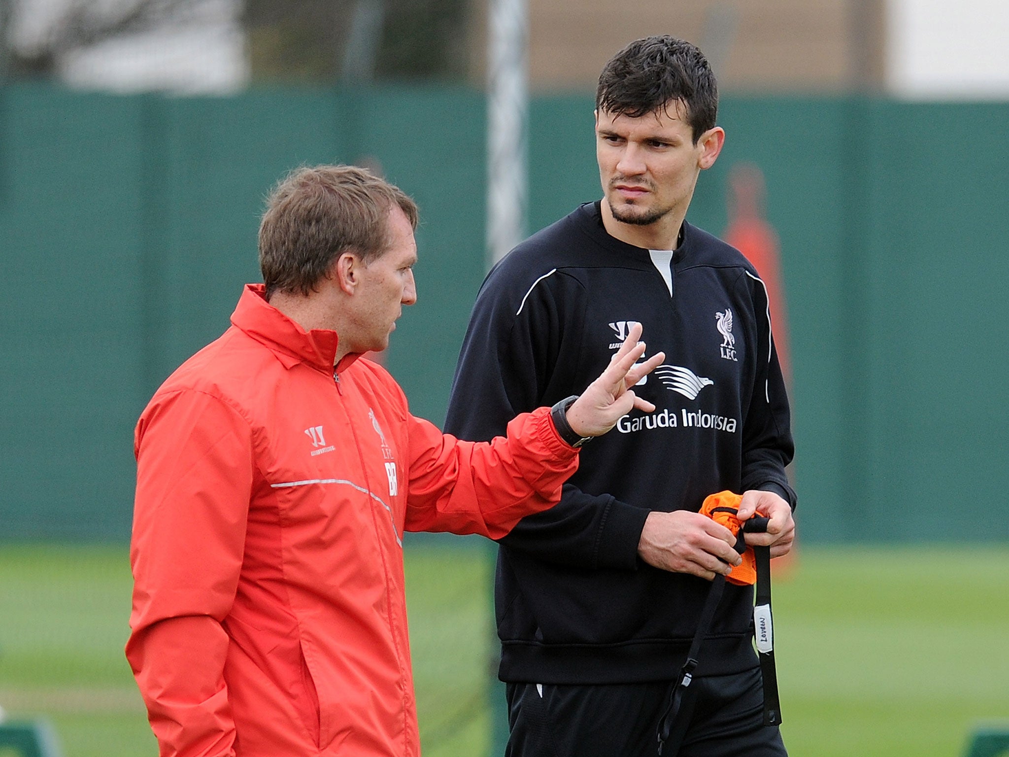Brendan Rodgers speaks to Dejan Lovren during Liverpool training