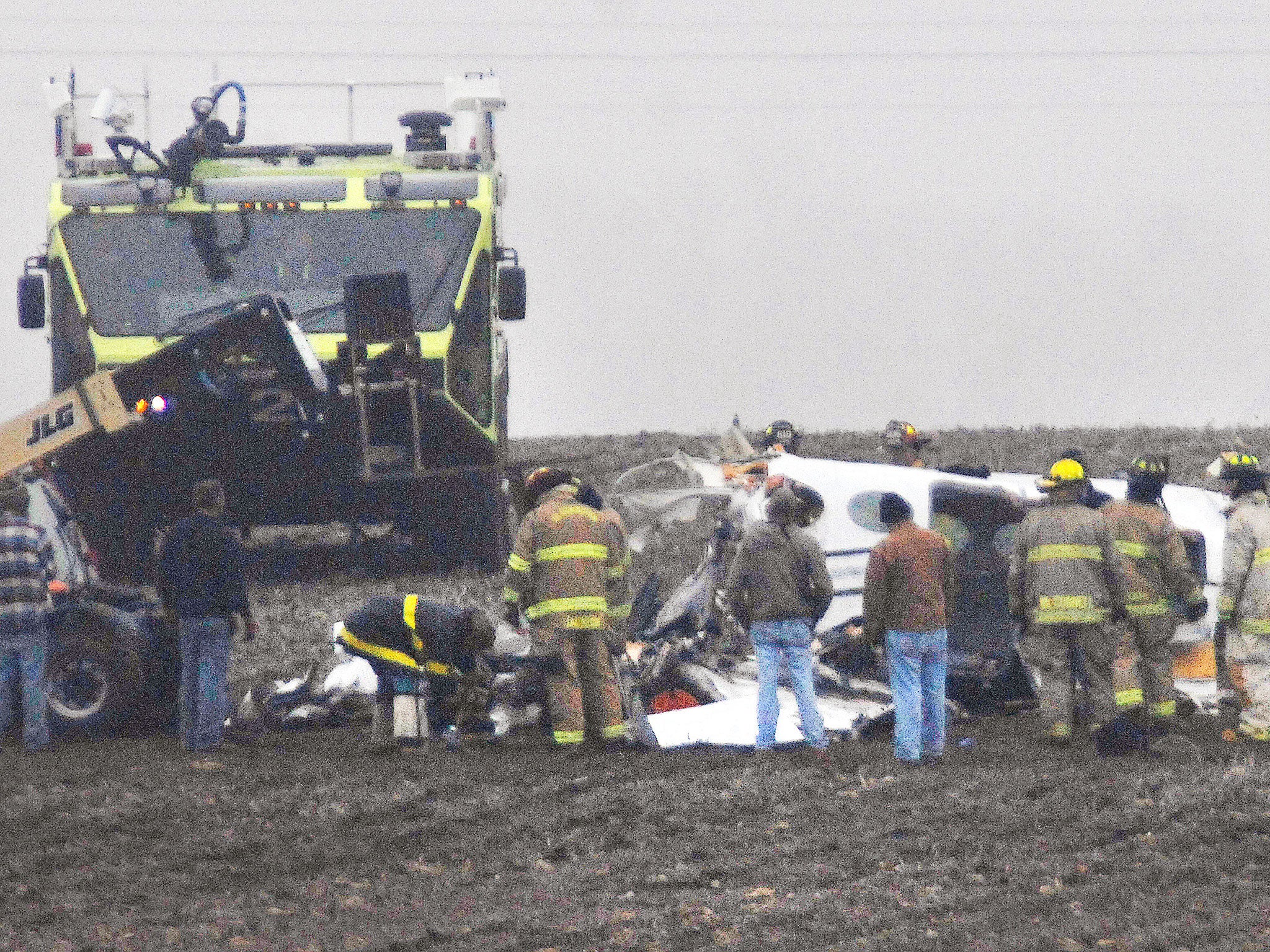 Investigators work in a thick fog at the site of small plane crash near Bloomington