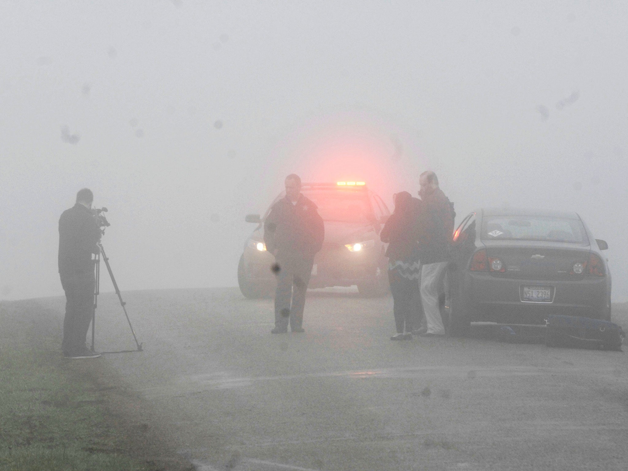 Emergency personnel and media gather at the scene of the plane crash near Bloomington