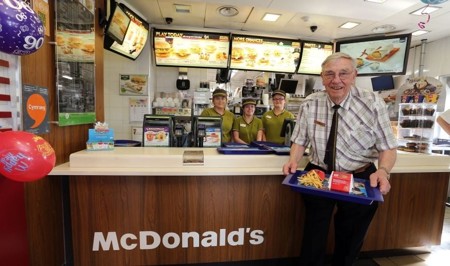 Bill at the service counter where he works part time since giving up retirement (Picture: Peter Byrne/PA)