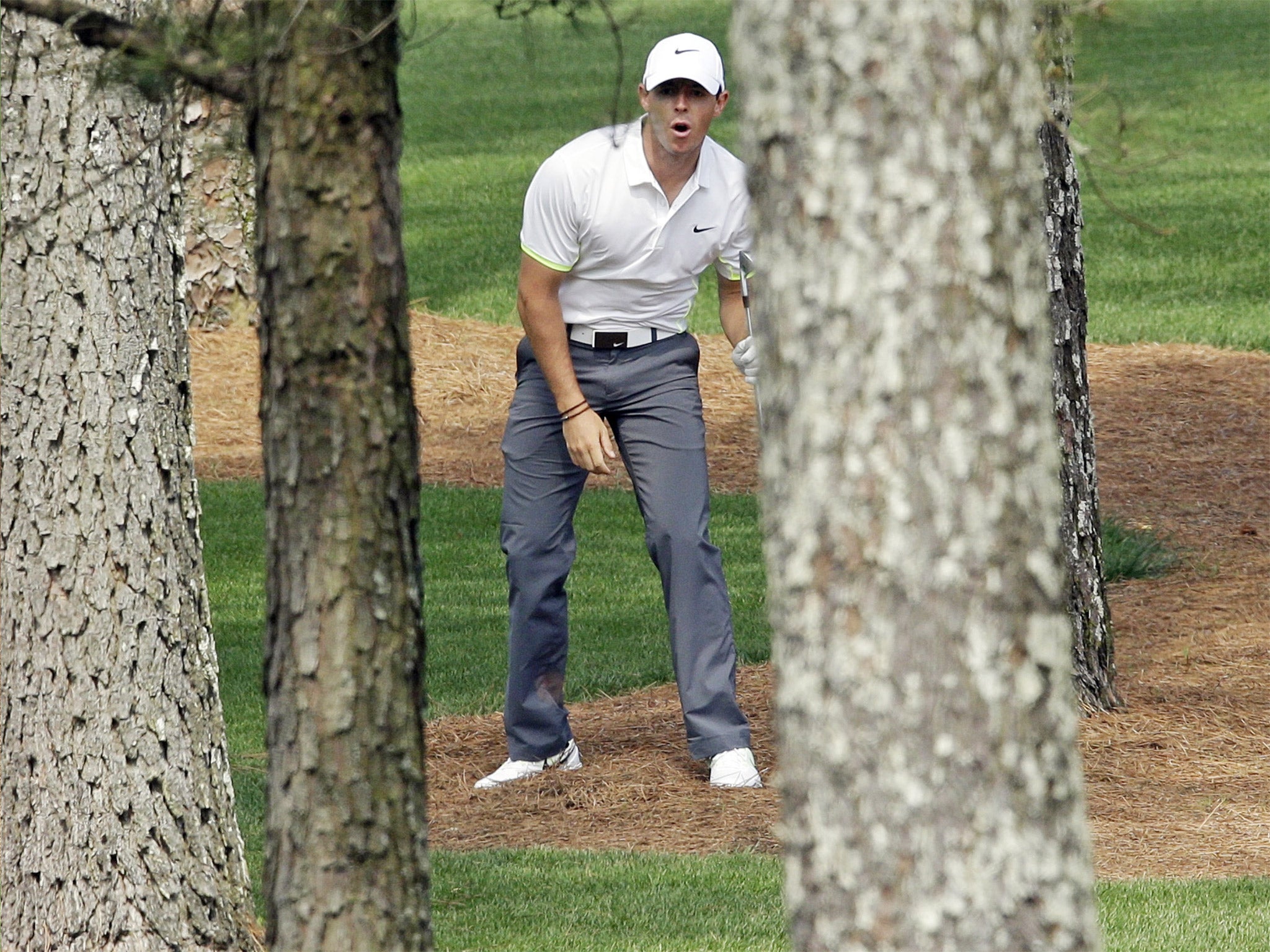 Rory McIlroy watches closely as his ball flies between the trees during his practice round at Augusta on Wednesday
