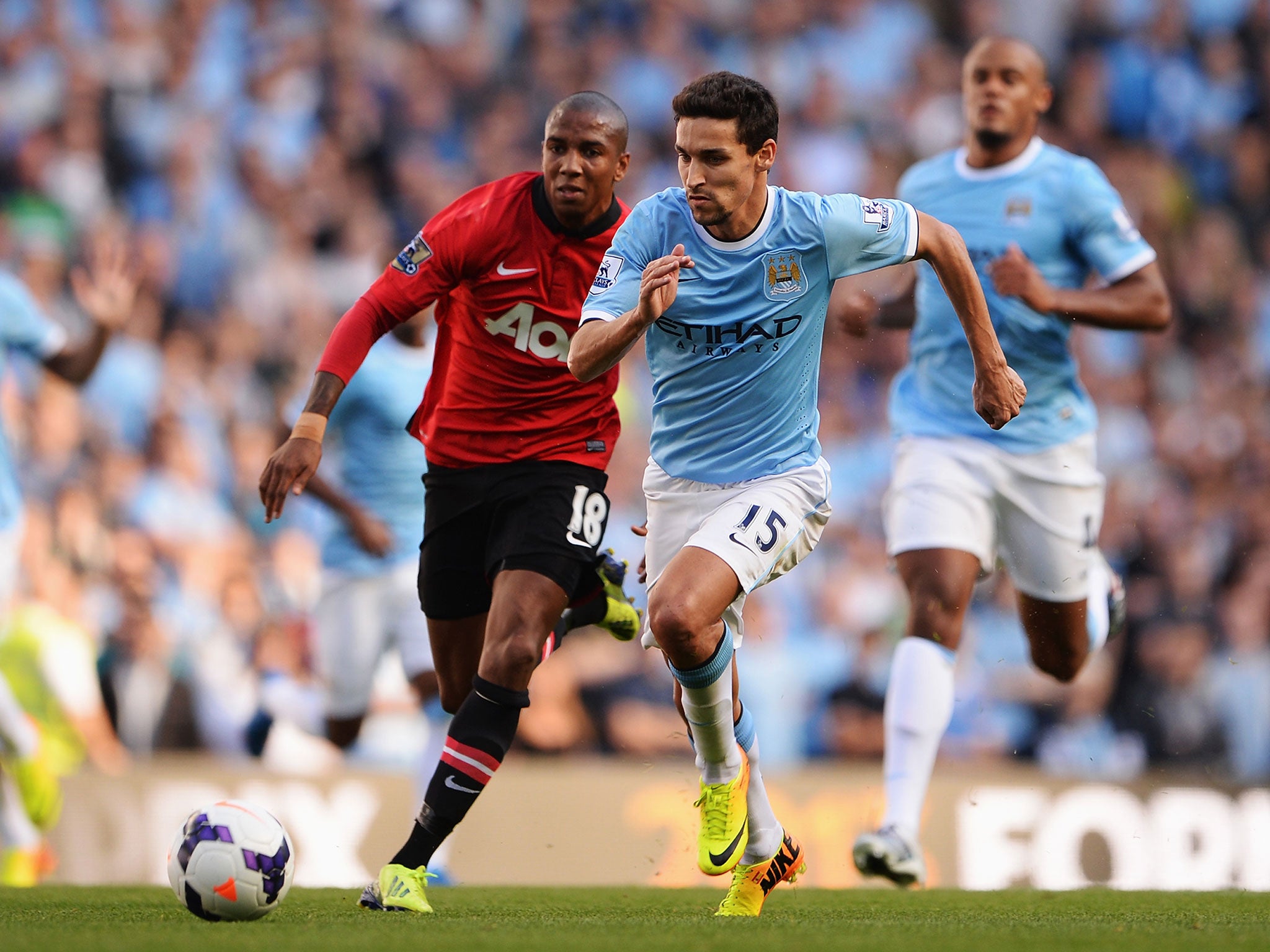 Young battles with Jesus Navas during the Manchester derby in 2013