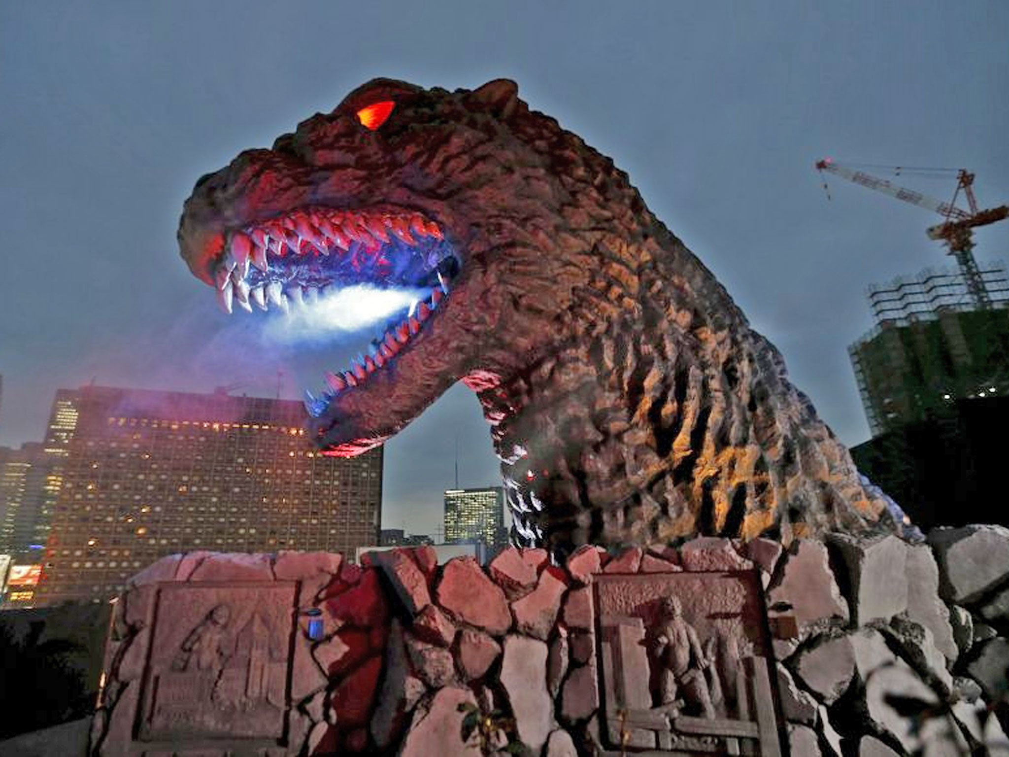 A real-scale head of Godzilla is displayed at the balcony of the newly-built commercial complex as a new Tokyo landmark during its unveiling at Kabukicho shopping and amusement district in Tokyo April 9, 2015. The skyscraper complex includes a hotel, mov