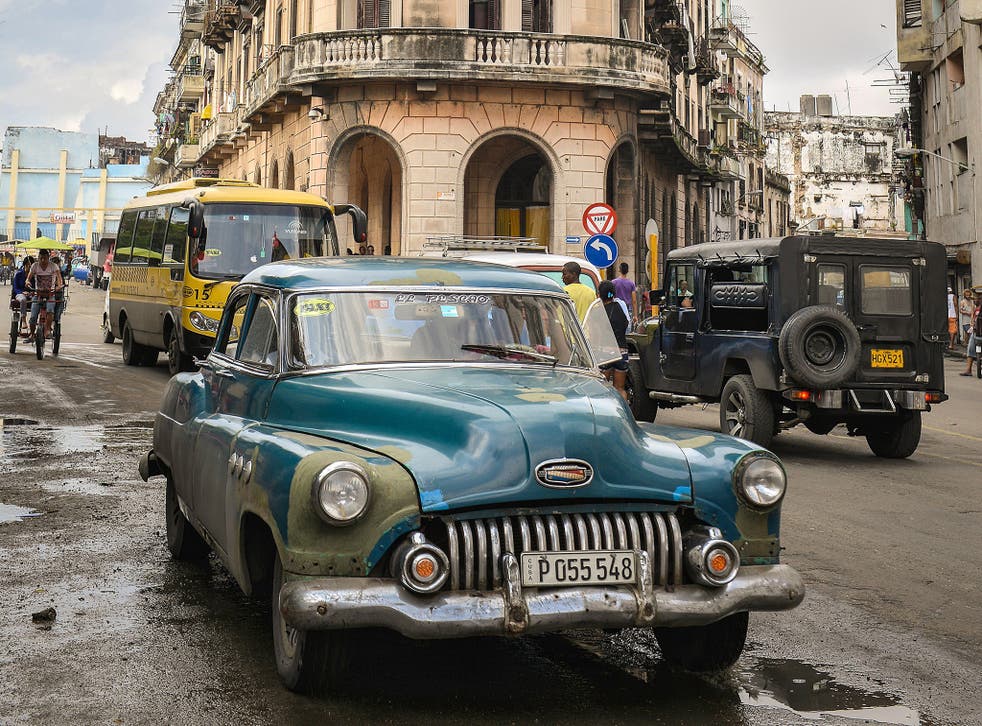 A vintage American car in a potholed Havana street; Cubans fear the return of US money would damage the city’s identity