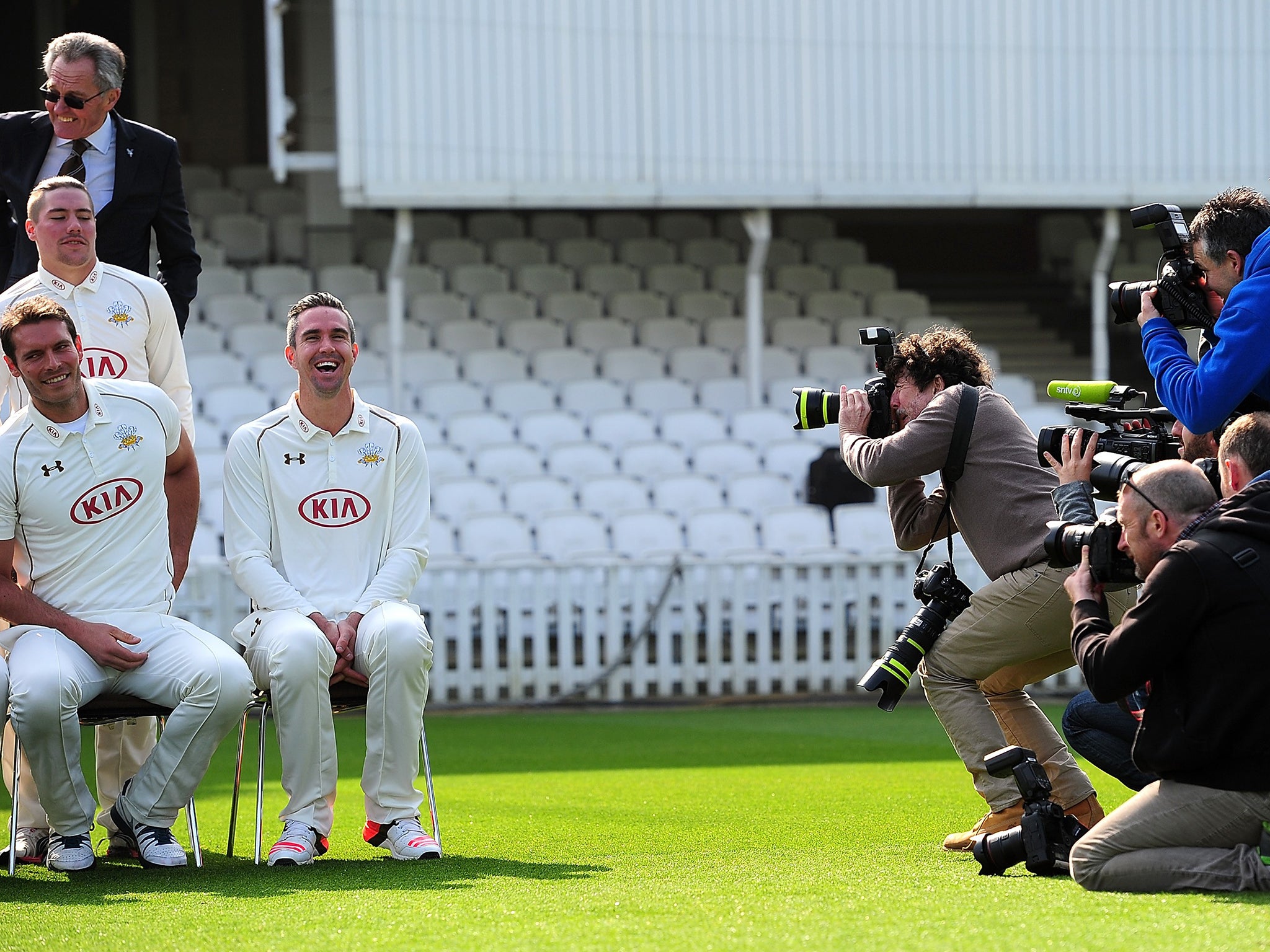 Kevin Pietersen is the centre of attention despite sitting on the end of Surrey’s
team photo yesterday