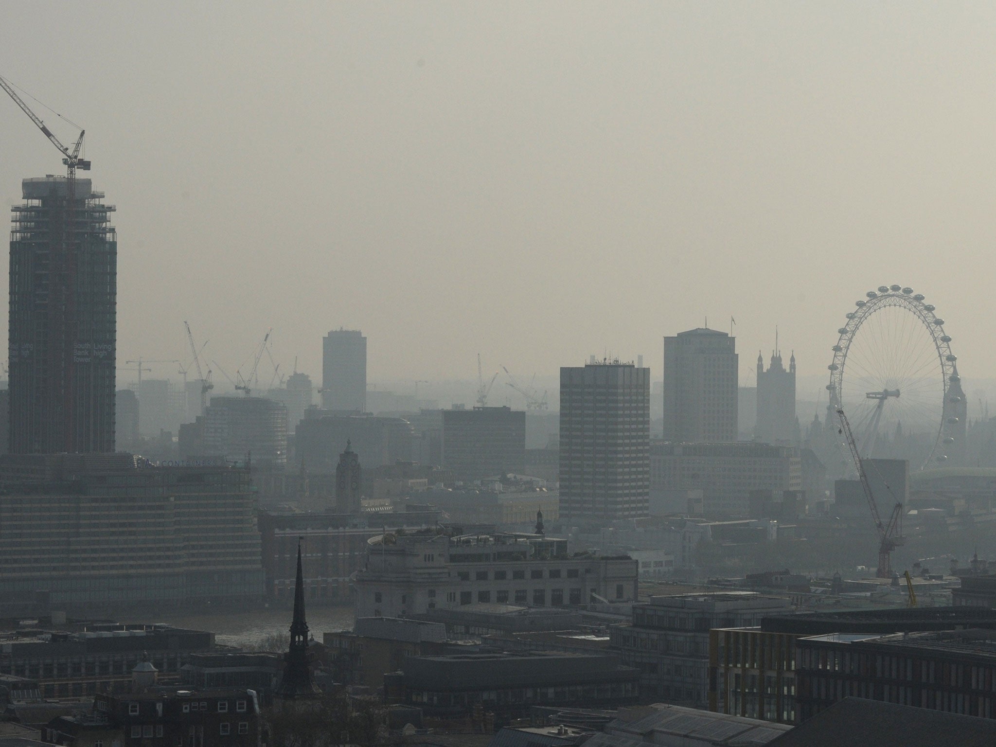 Air pollution obscures the view of the London eye in central London on April 9, 2015