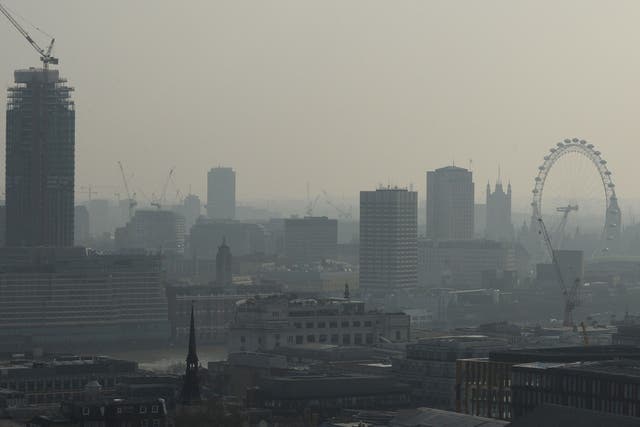 Air pollution obscures the view of the London eye in central London on 9 April 2015