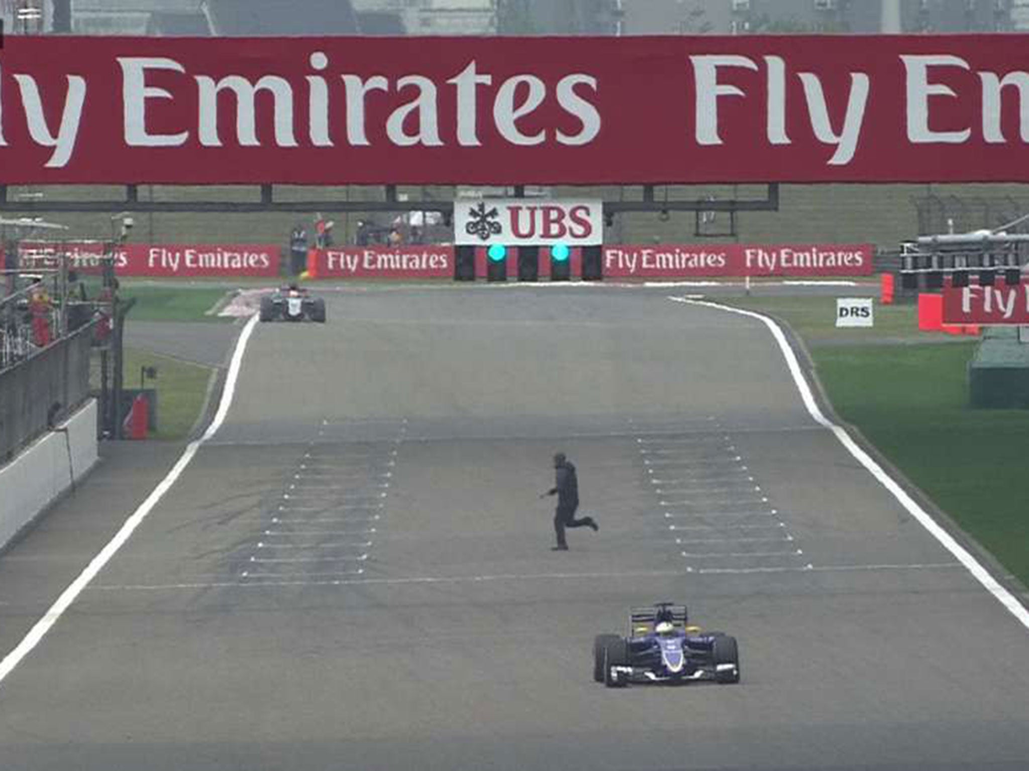 A man runs onto the Shanghai track during second F1 practice