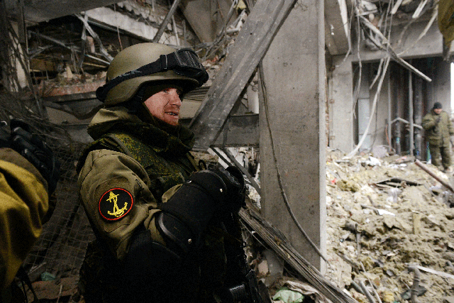 Pro-Russian separatist commander 'Motorola' stands inside a destroyed airport building in the eastern Ukrainian city of Donetsk, on February 26, 2015