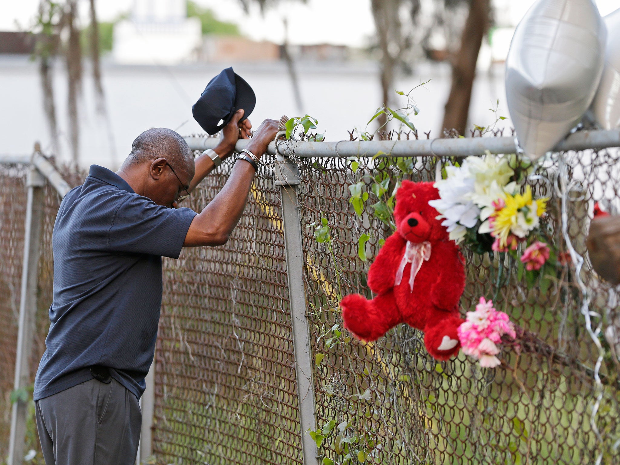 Jerome Flood, of James Island, S.C., pauses for a moment of silence at the scene the killing of Walter Scott by a North Charleston police officer Saturday after a traffic stop in North Charleston. Scott was best man at Flood's wedding and Flood said he wanted to see where it happened. The officer, Michael Thomas Slager, has been fired and charged with murder