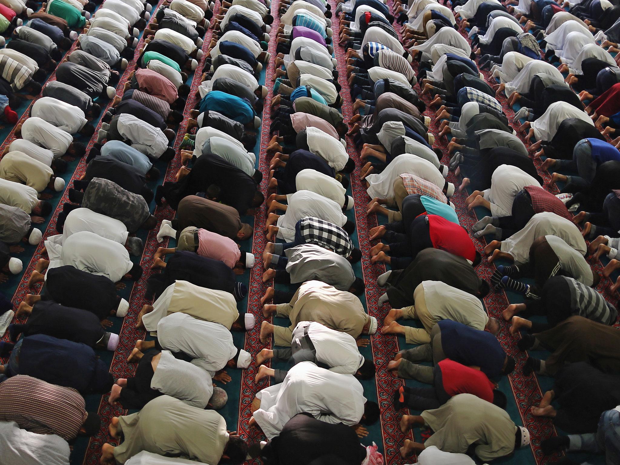 In this file image, Muslim men pray during Eid celebrations on August 7th 2013