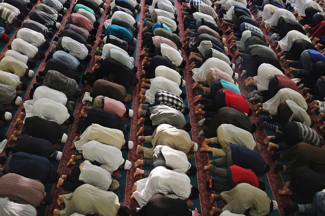 In this file image, Muslim men pray during Eid celebrations on August 7th 2013