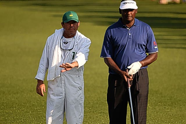 Vijay Singh consults his caddie Cayce Kerr during the first round