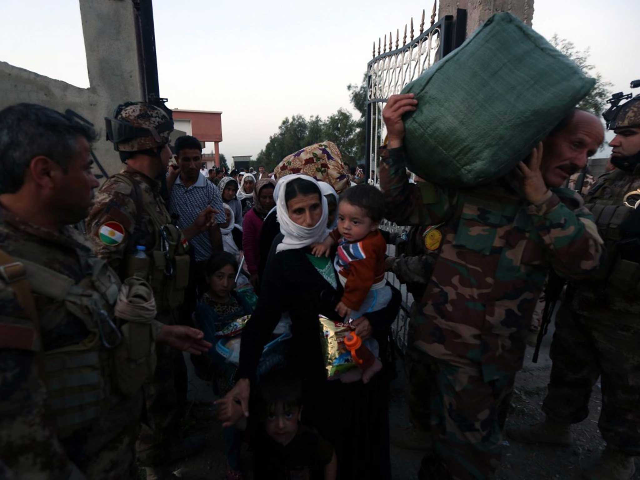 Peshmerga forces help Yazidis freed by Isis in northern Iraq earlier this week
