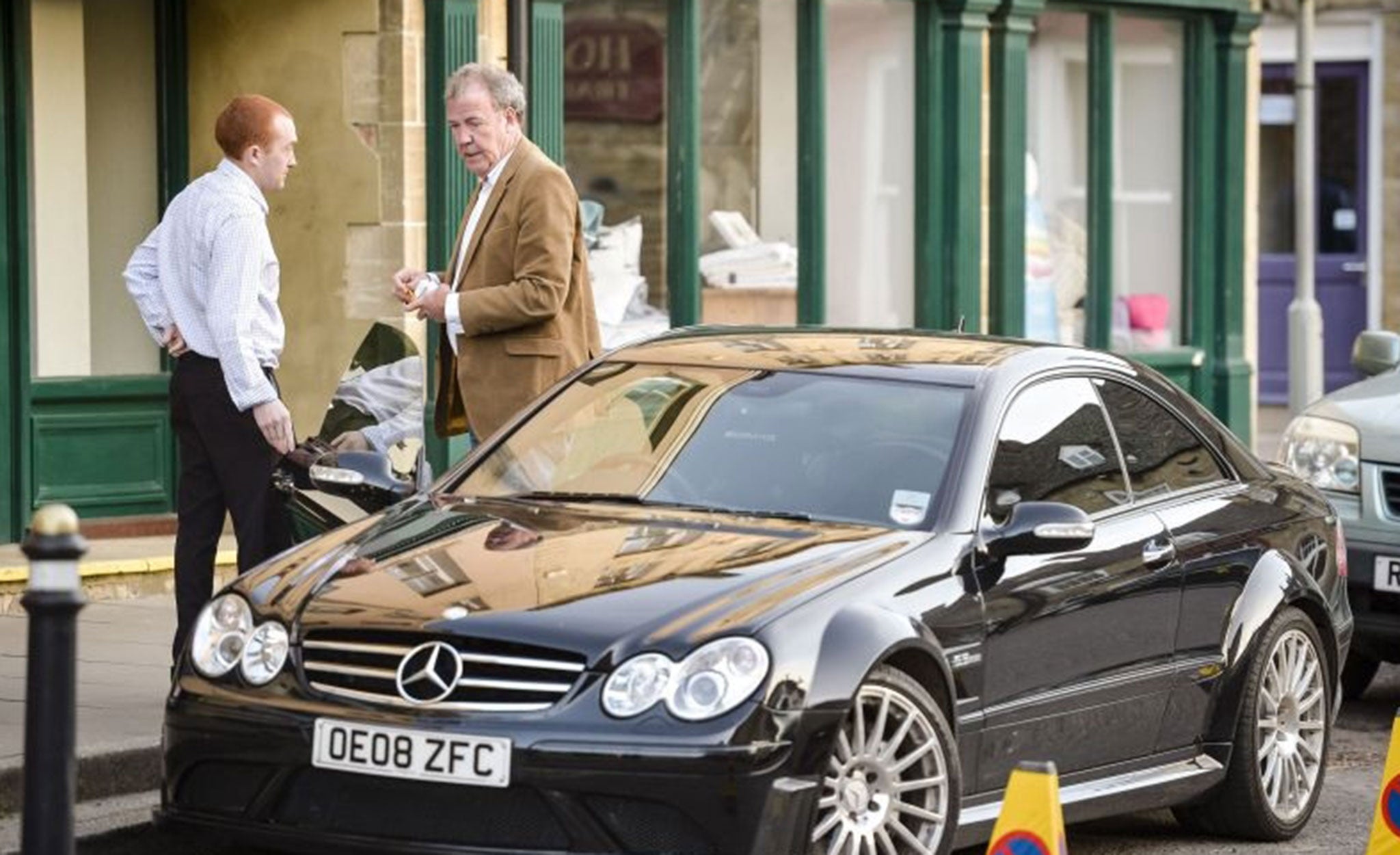 Jeremy Clarkson gets out of his car as he arrives at Chipping Norton