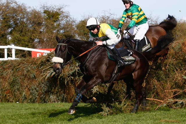 Many Clouds leads Shutthefrontdoor on the way to Grand National glory