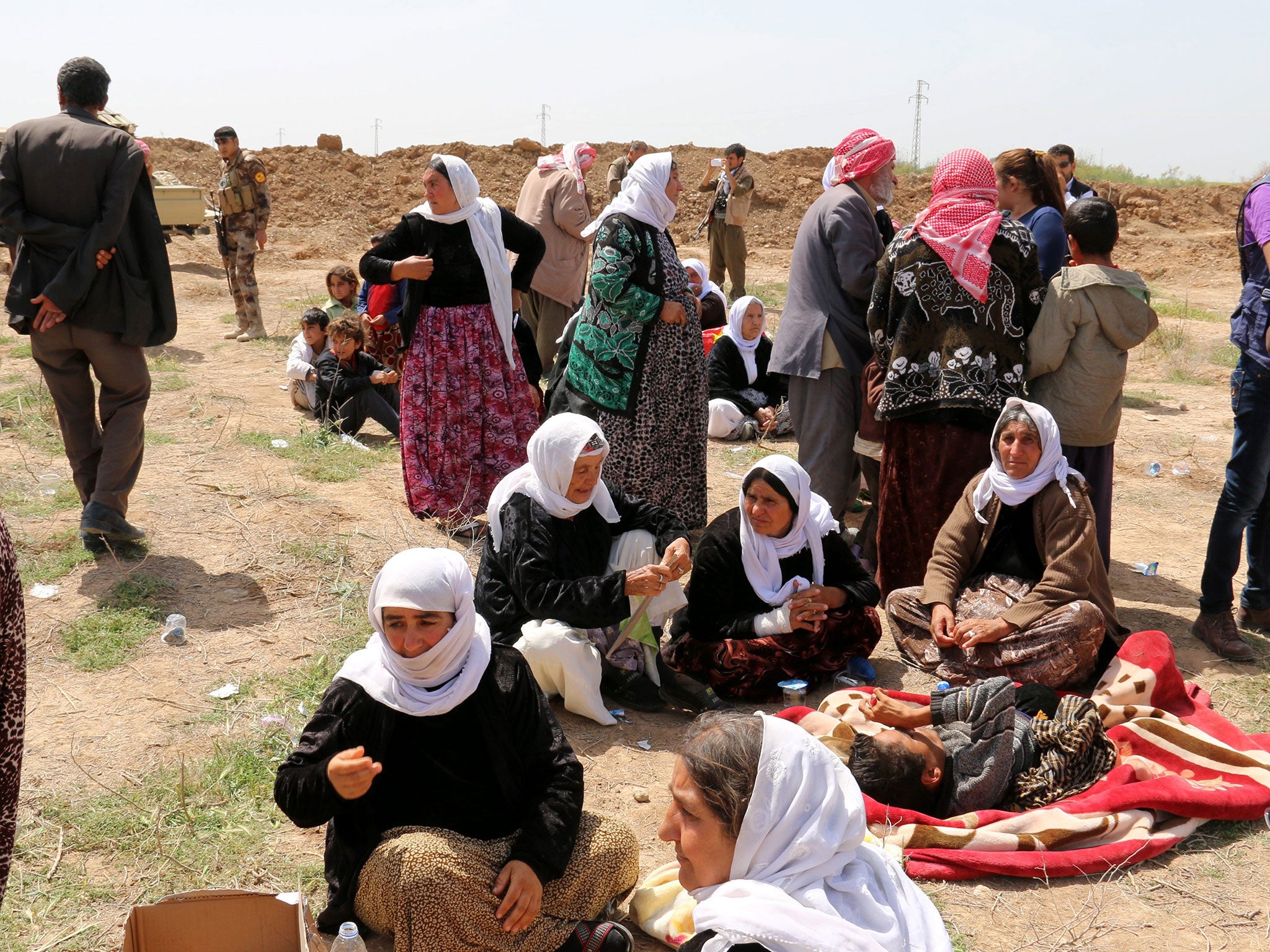 Iraqi Yazidi women are seen at the entrance of a checkpoint in Kirkuk after their release by Isis