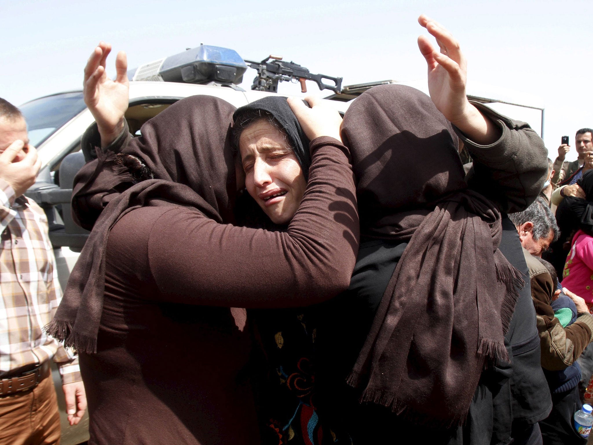 Members of the minority Yazidi sect who were newly released hug each other on the outskirts of Kirkuk April 8, 2015