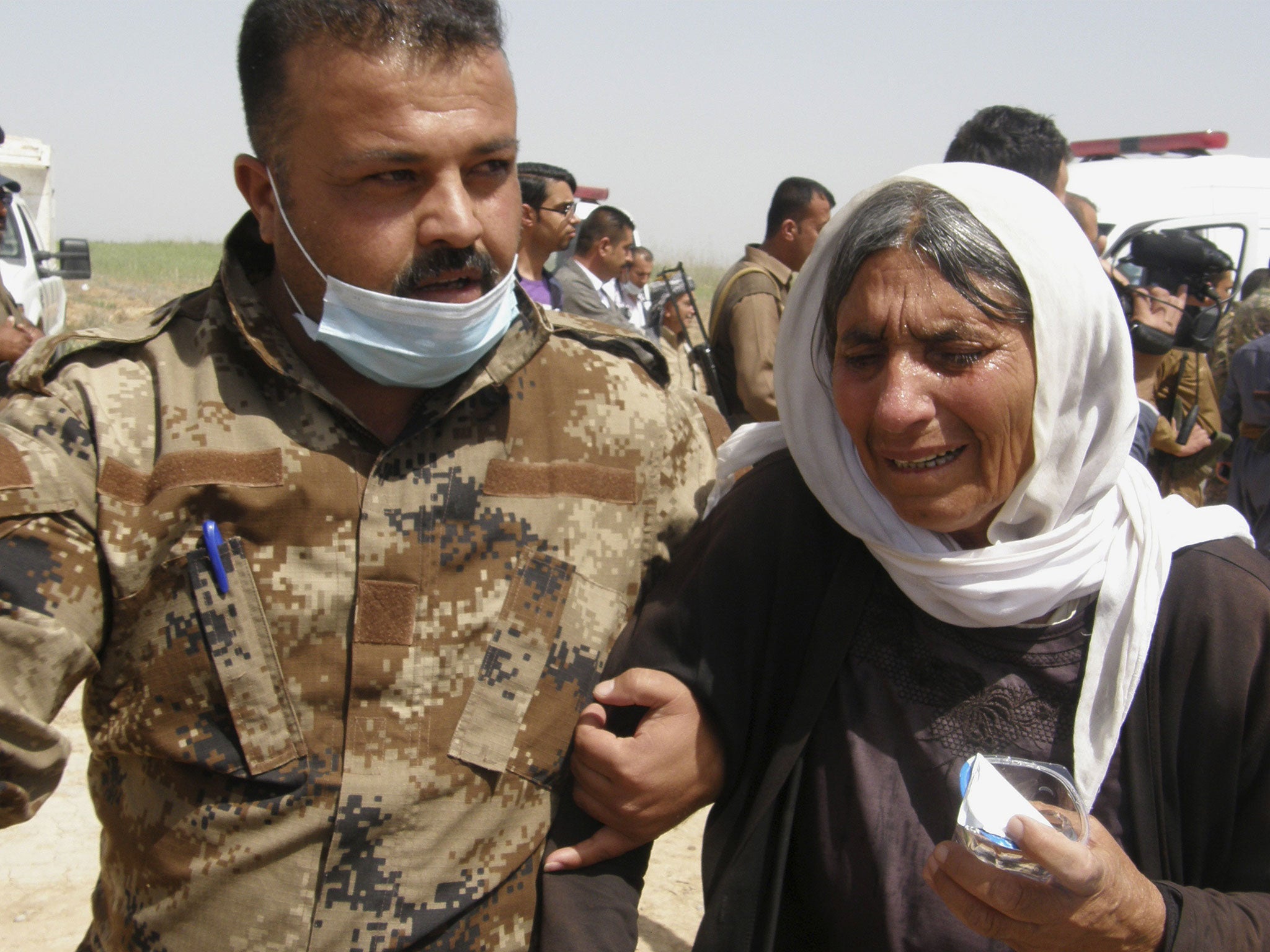 A Yazidi, right, released by Islamic State group militants arrives in Kirkuk