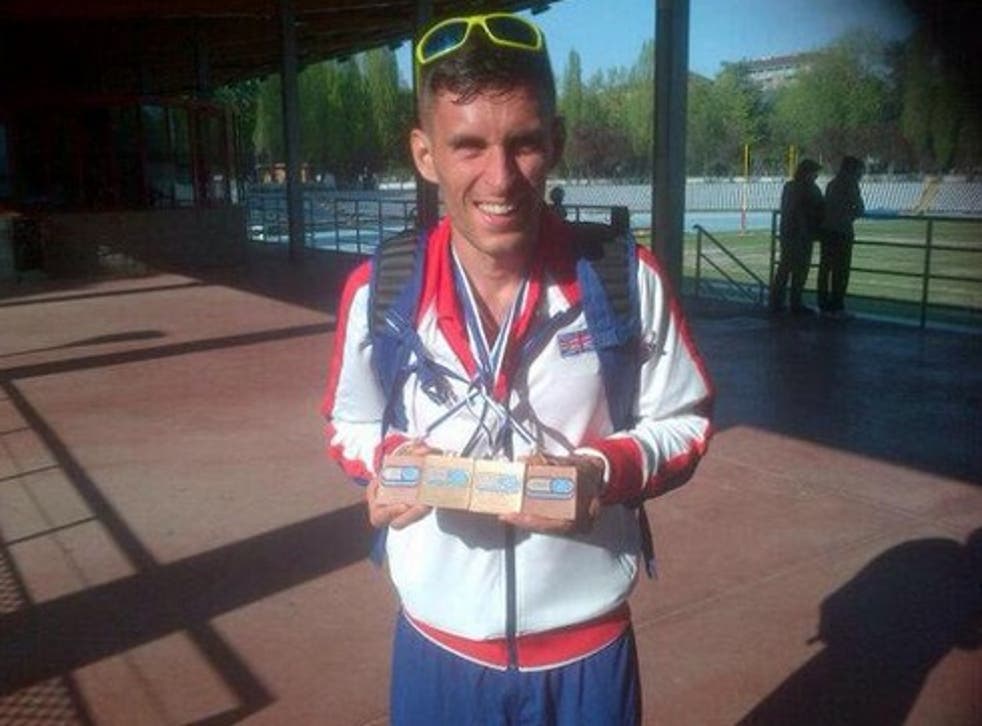 Robbie Britton holds his medals after the 24-hour race
