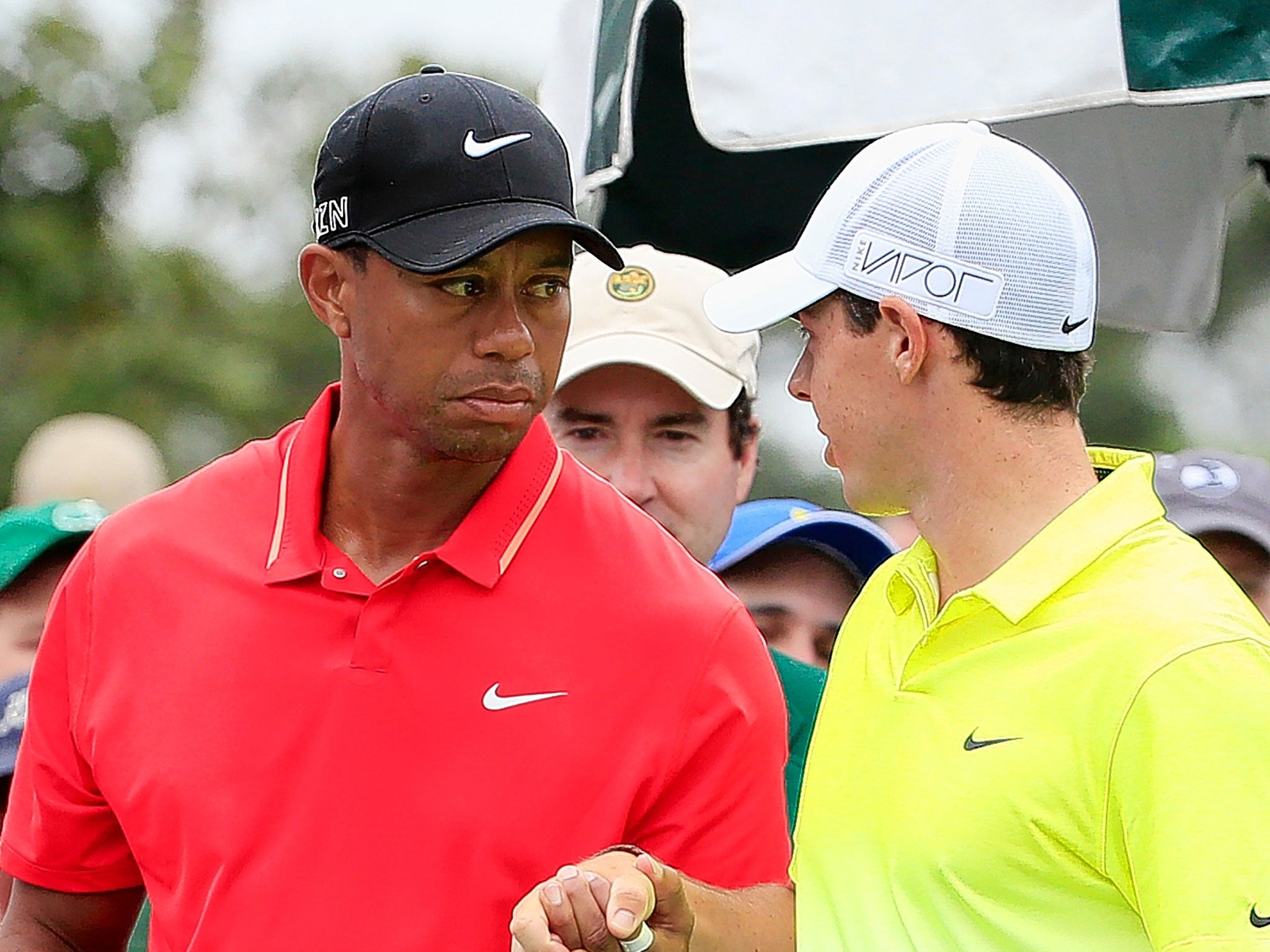Tiger Woods and Rory McIlroy shake hands as they wait on the first tee before the final round at Augusta
